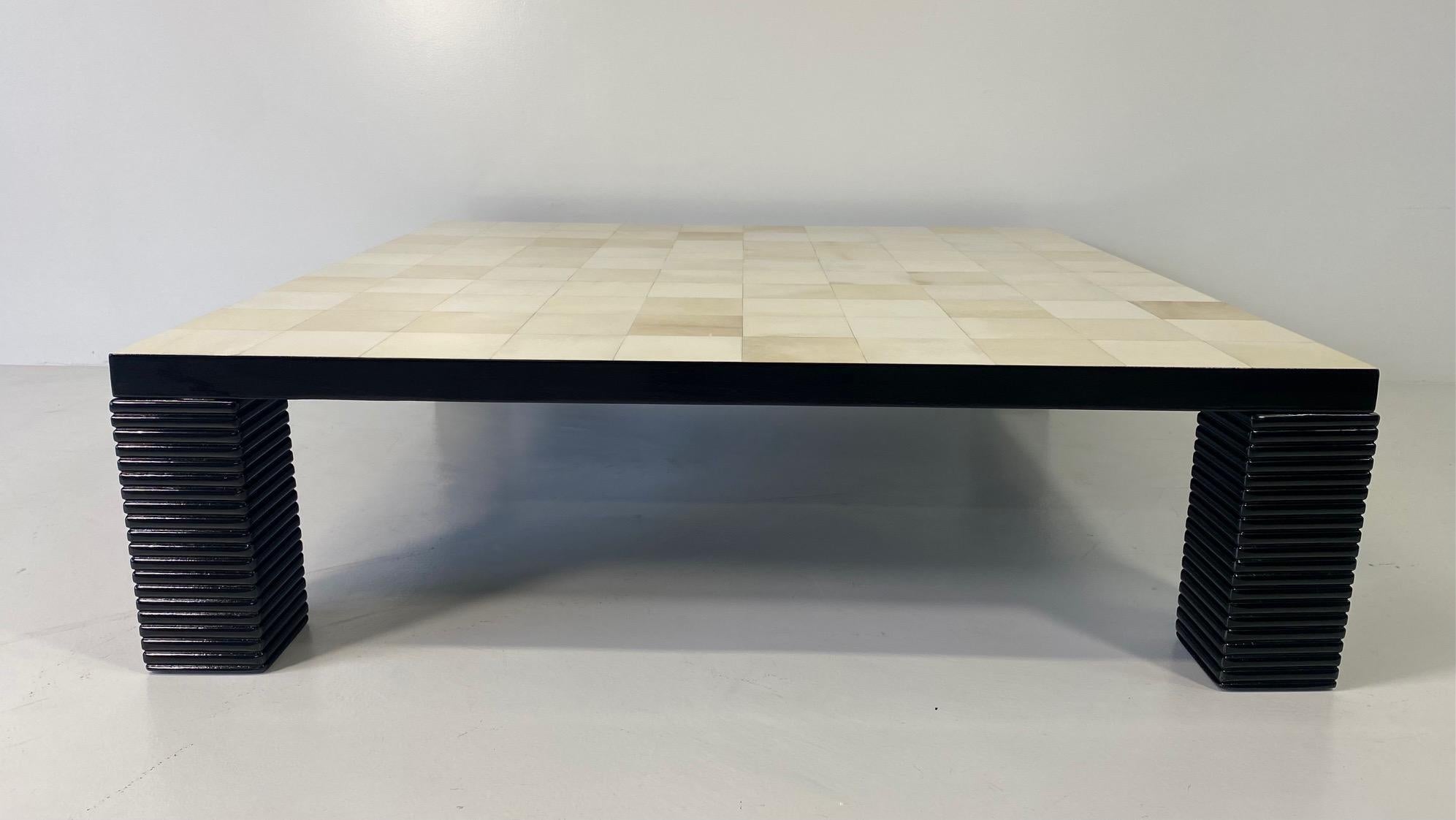 This beautiful and rare Art Deco style coffee table was produced in Italy.
The top is covered with 100 squares of parchment, while the edge and the particular legs are black lacquered.
 