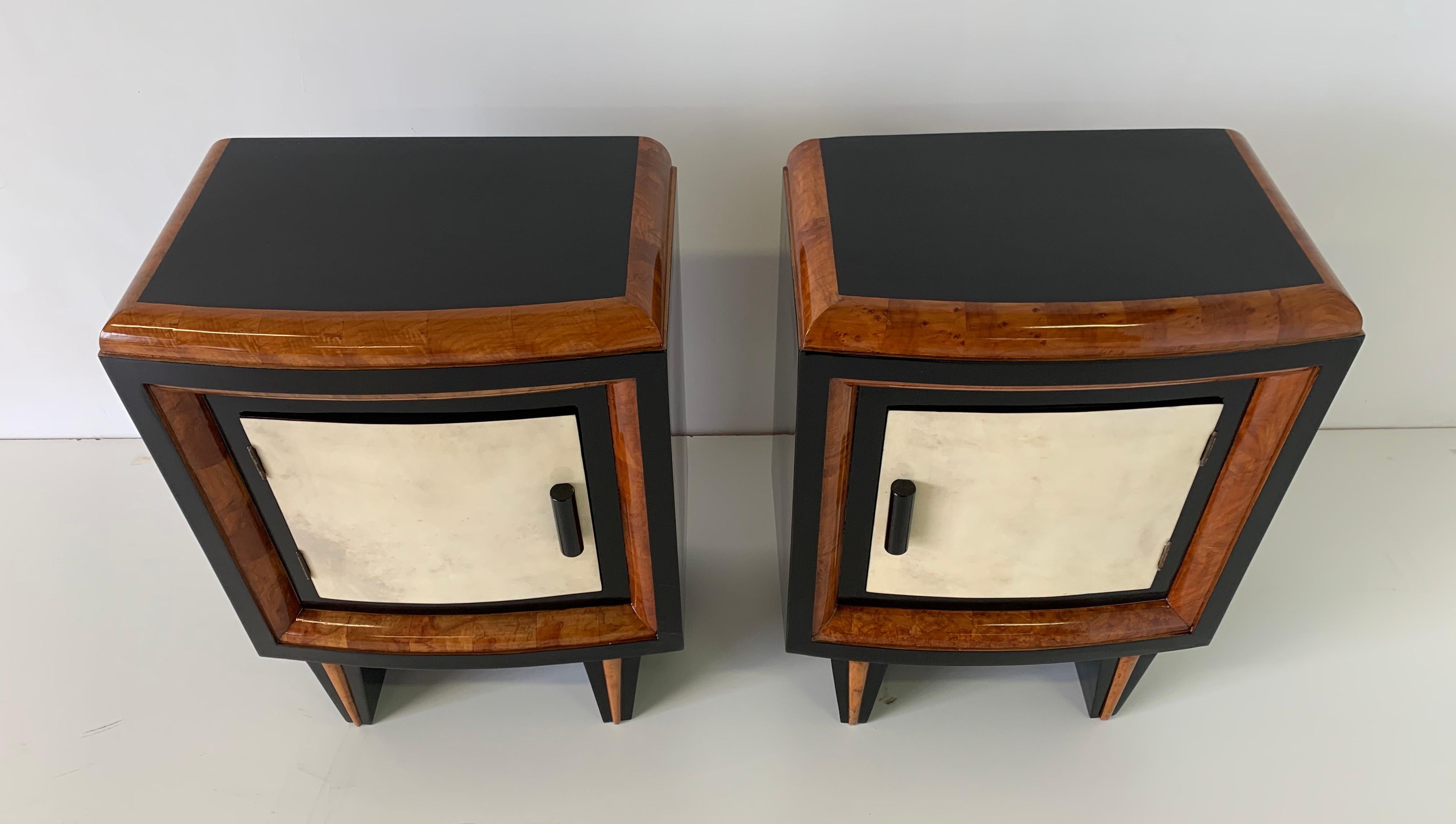 Italian bedside tables from the 1930s produced in Italy.
The front of the doors are in parchment while the profiles are in walnut.
The structure and handles are in black lacquered wood.
Completely restored.
      