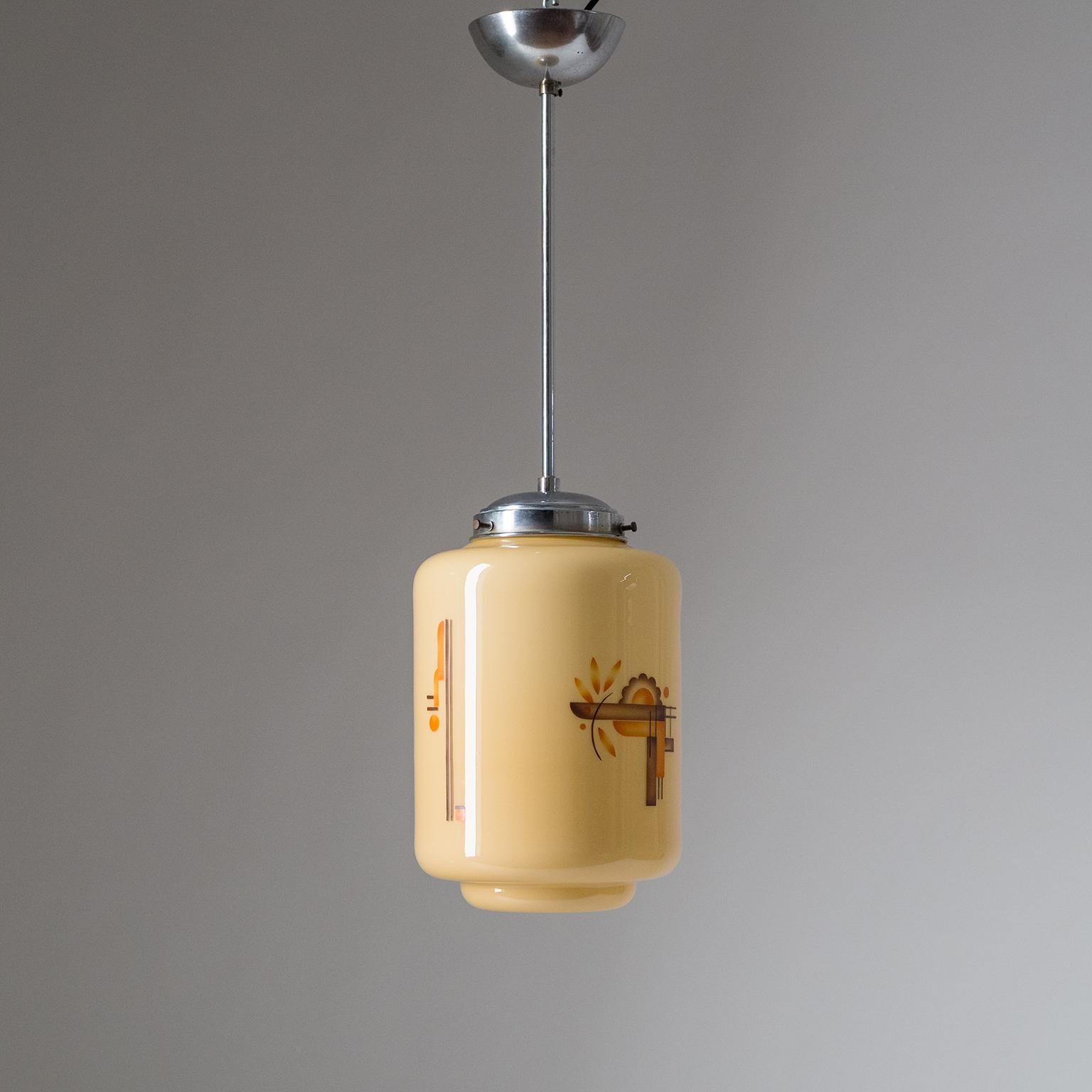 Rare Italian Art Deco or Bauhaus pendant from the late 1920s-early 1930s. The blown glass diffuser has an amber colored out layer and a white inner casing, which combined give it a sand color effect. The glass body has orange and brown enameled