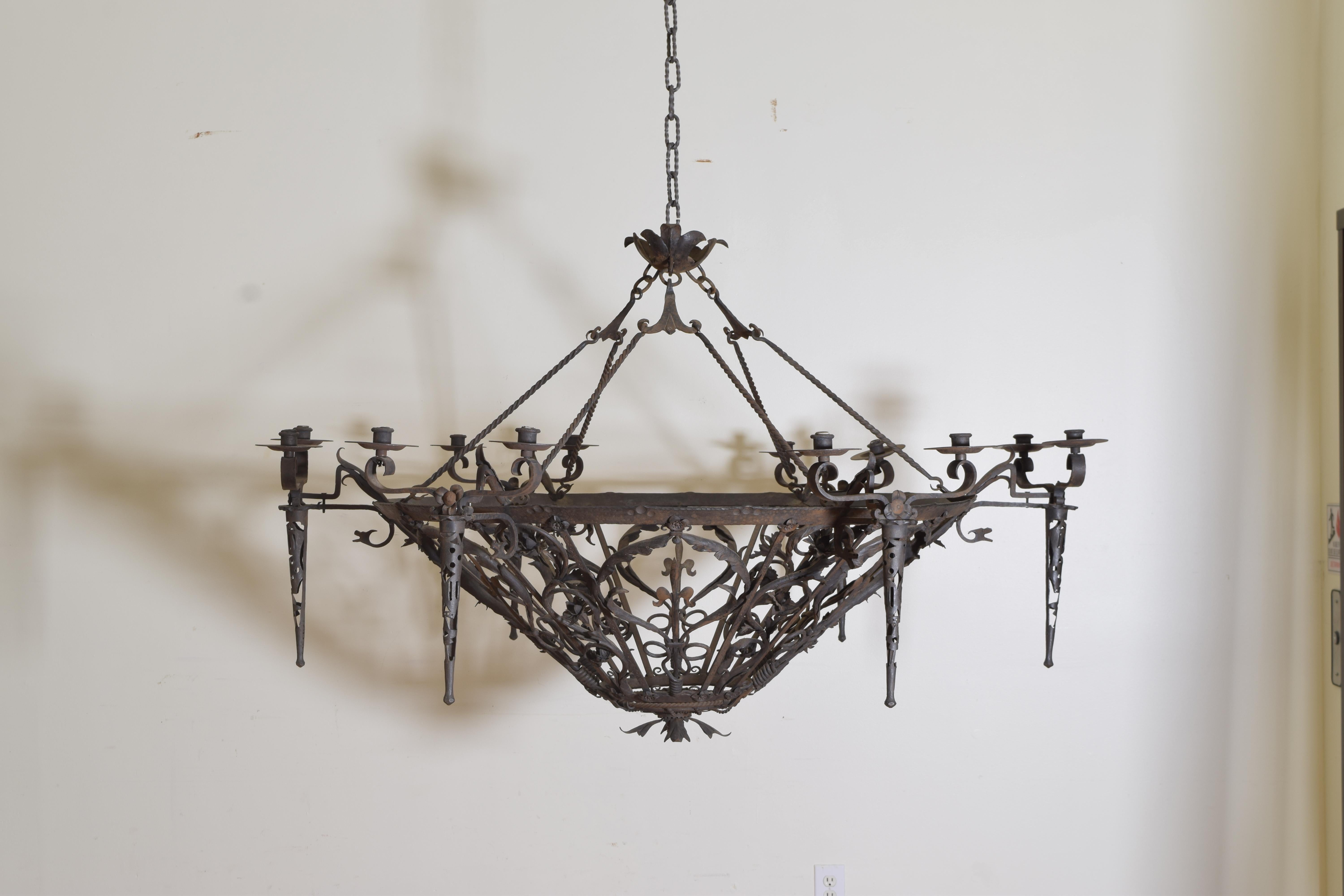This wonderful and large expertly wrought iron fixture from the Piemonte region of Italy is in a bowl shape and includes original crossbar that was custom made to fit between beams in the house in which it was found, the body of the chandelier
