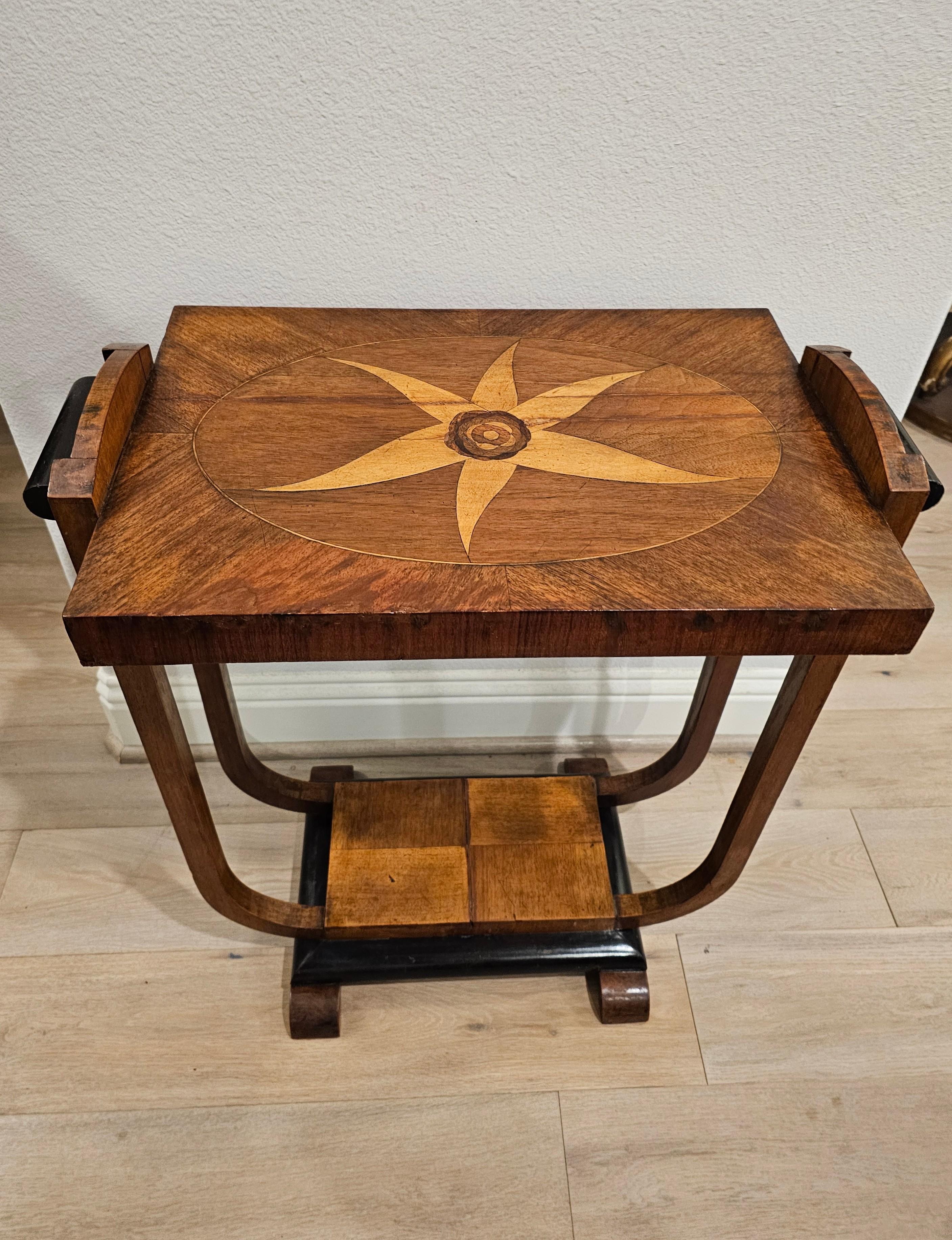 A scarce authentic Italian Art Deco Streamline Moderne Period mahogany marquetry side table.

Italy, circa 1930, hand-crafted, having a rectangular mahogany top inlaid with large contrasting marquetry floral rosette, flanked by raised profiled sides