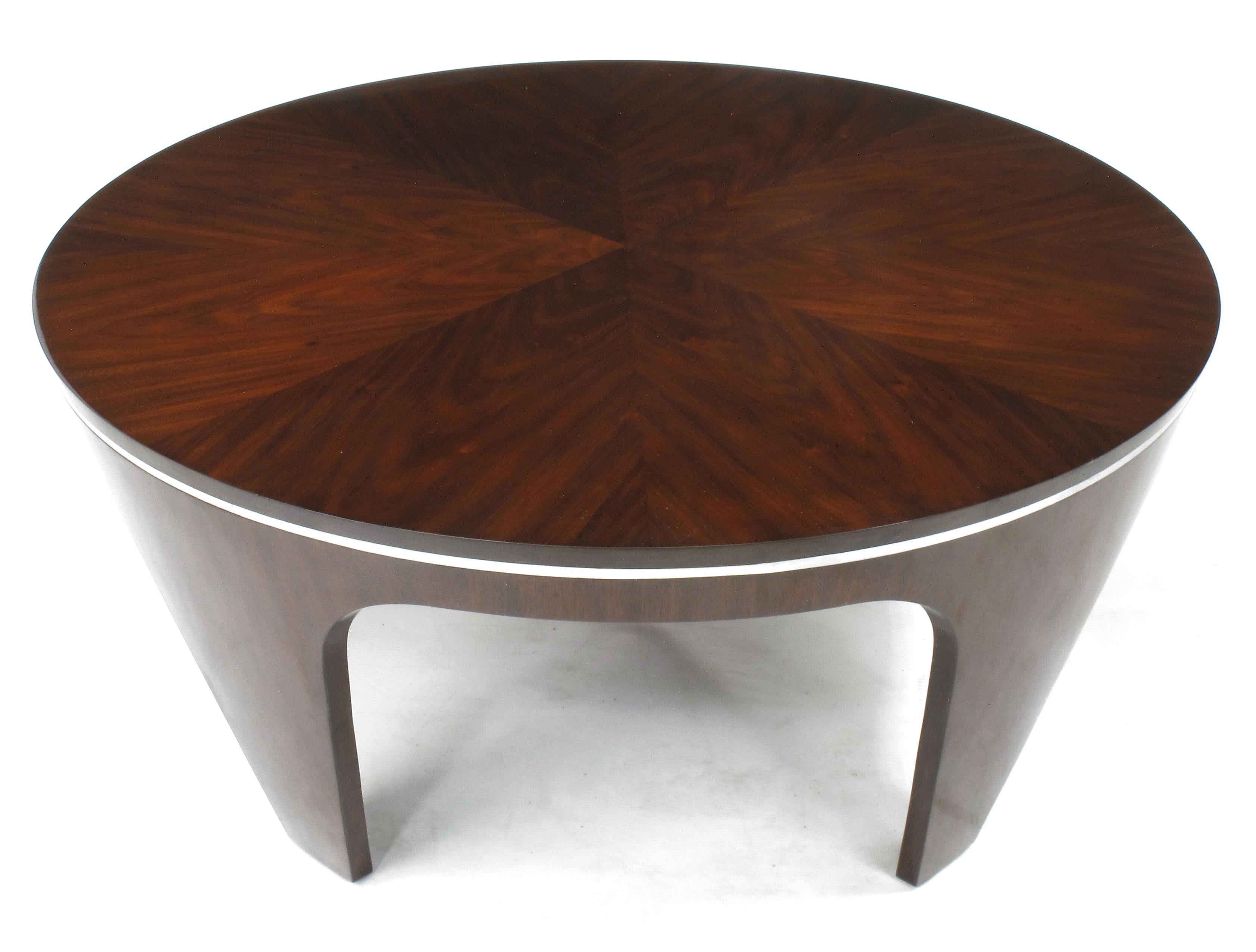 Art Deco inspired high gloss mahogany coffee table with chrome banding accent and parquetry top. Most likely of Italian origin, the sculptural legs are tapered inward creating a striking Silhouette. Comes with a protective glass top to keep the