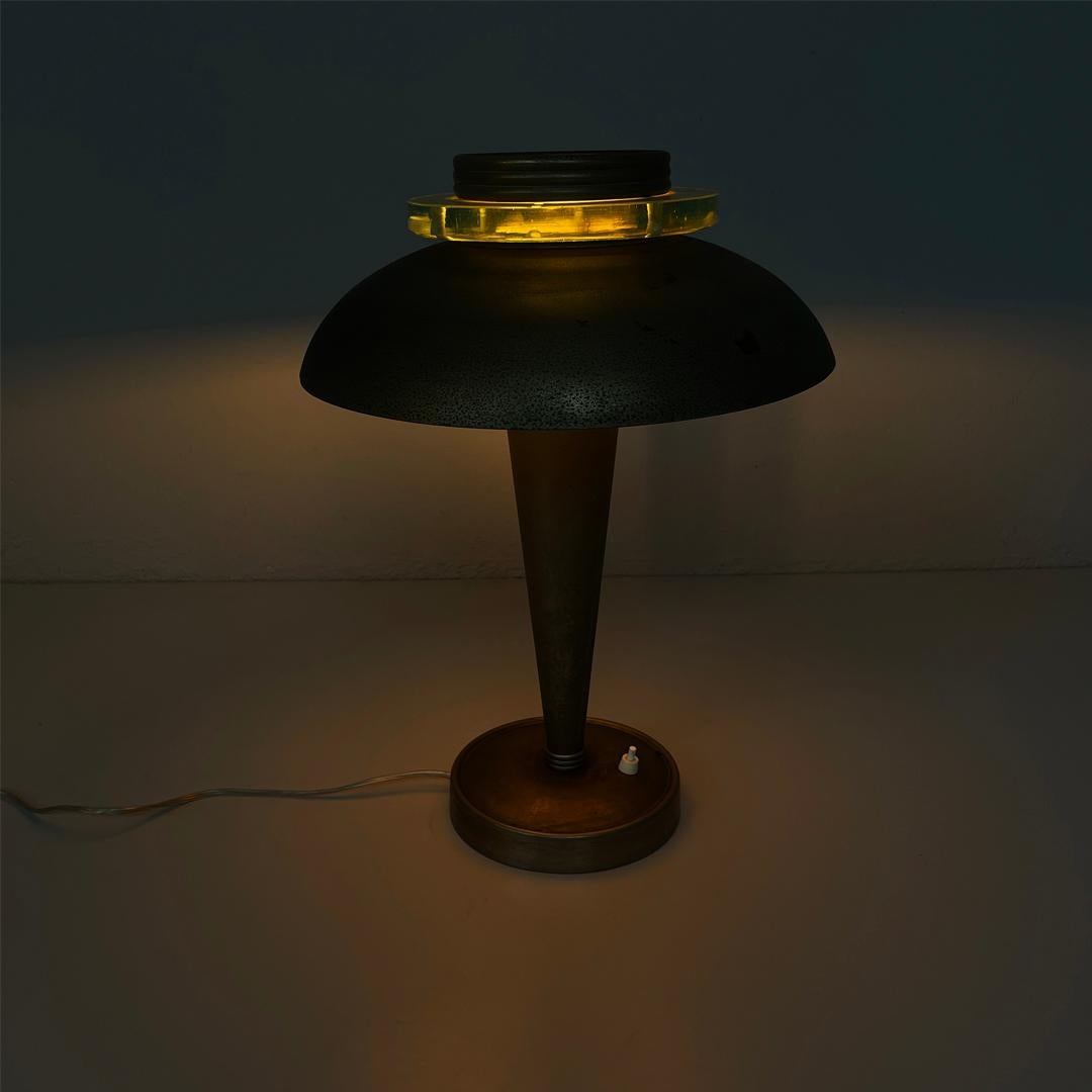 Italienische runde Tischlampe aus Messing und Glas, 1920er Jahre, Art Deco
Tischleuchte mit rundem Sockel. Der große runde Lampenschirm ist aus Messing und wird von drei Armen getragen.
Sie hat einen weißen runden Diffusor und eine dekorative