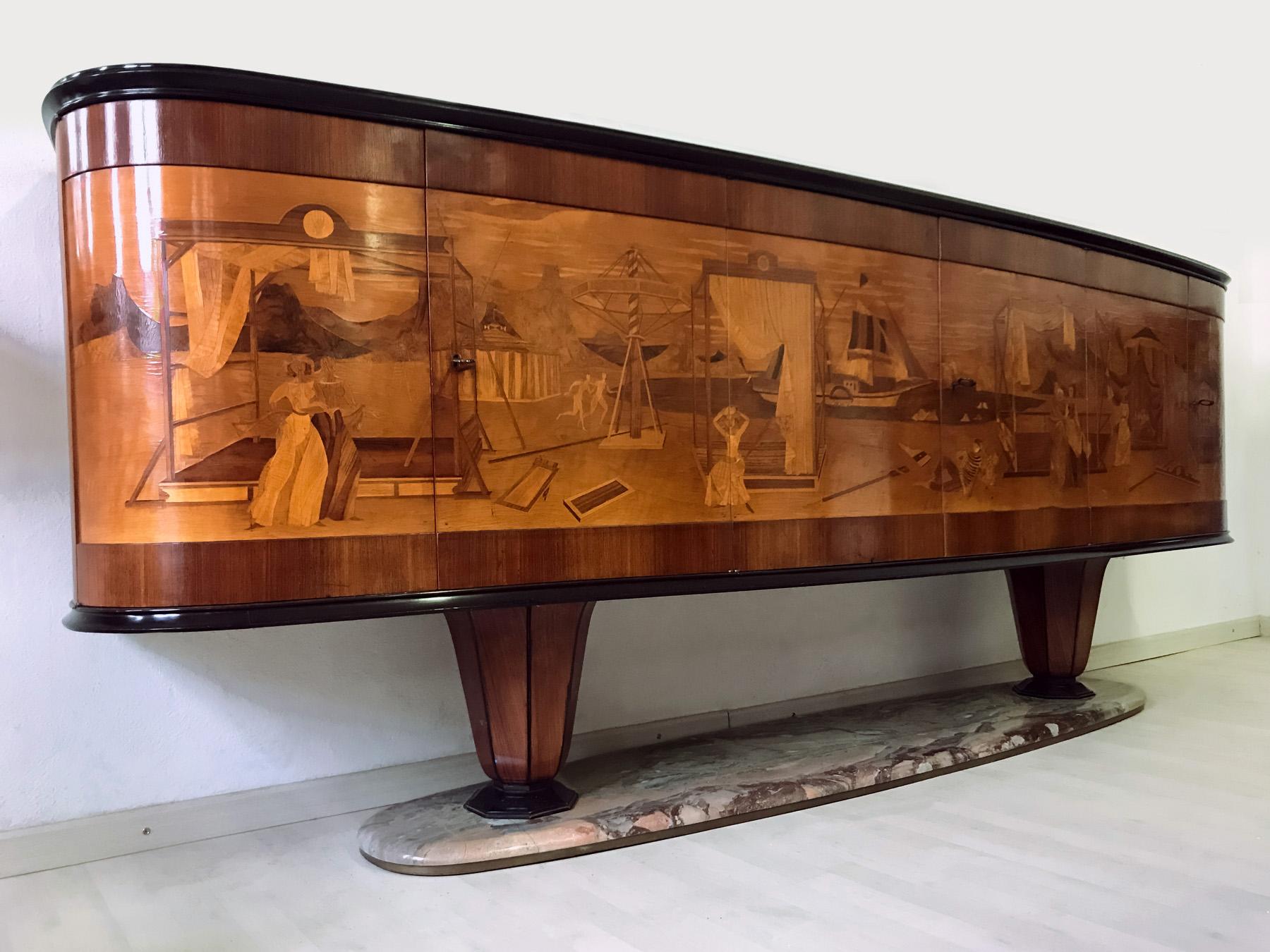 Important and very rare sideboard created by Vittorio Dassi in the 1940s.
The three double doors hide internally shelves on the sides and an illuminated Bar in the central compartment, externally all decorated with a spectacular marquetry ascribed