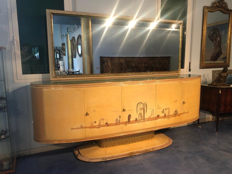 Italian Art Deco sideboard in lacquered wood parchment Osvaldo Borsani's style, Italy 1940.
Beautiful movement of the lines on the front, precious inlays on the doors, base in marble, interiors in maple. 
The dressing table is detachable. The wet