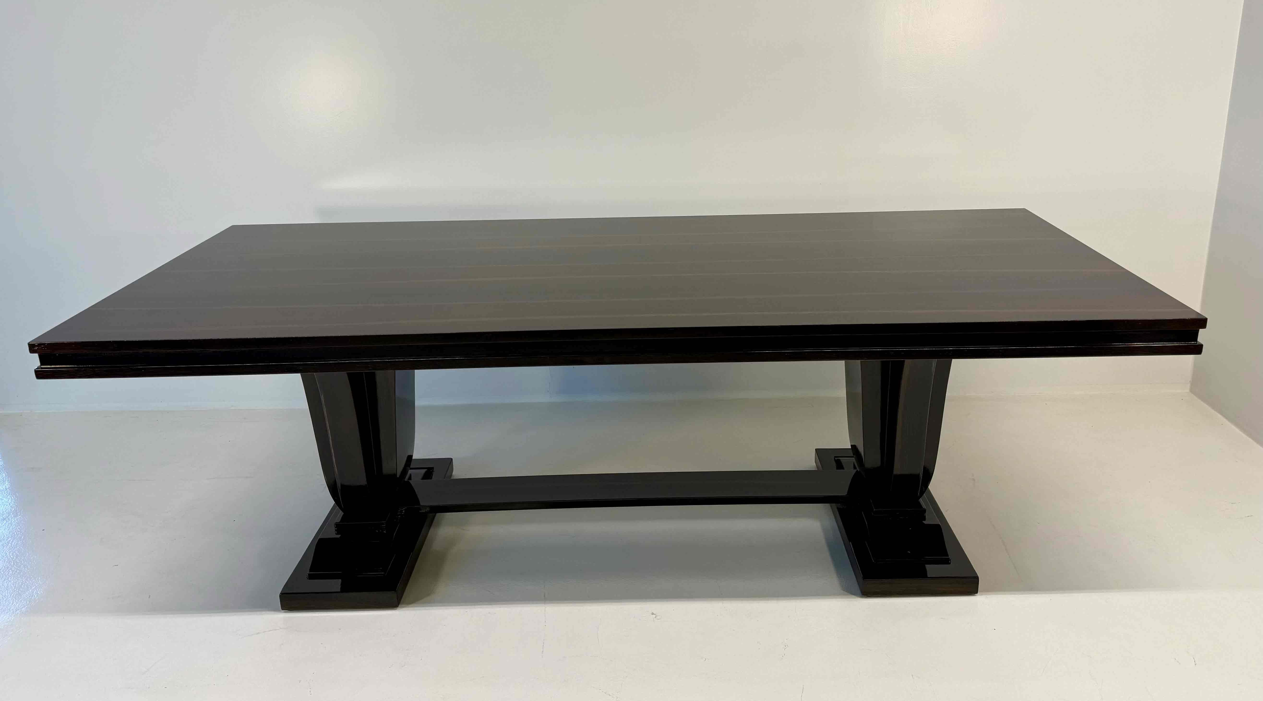 Elegant Italian Art Deco table produced in the 1940s, crafted in smoked oak with sleek black profiles.
The dark trim outlines the top and the structure, enhancing the natural texture and depth of the oak.
The table is extendable, with a discreet and