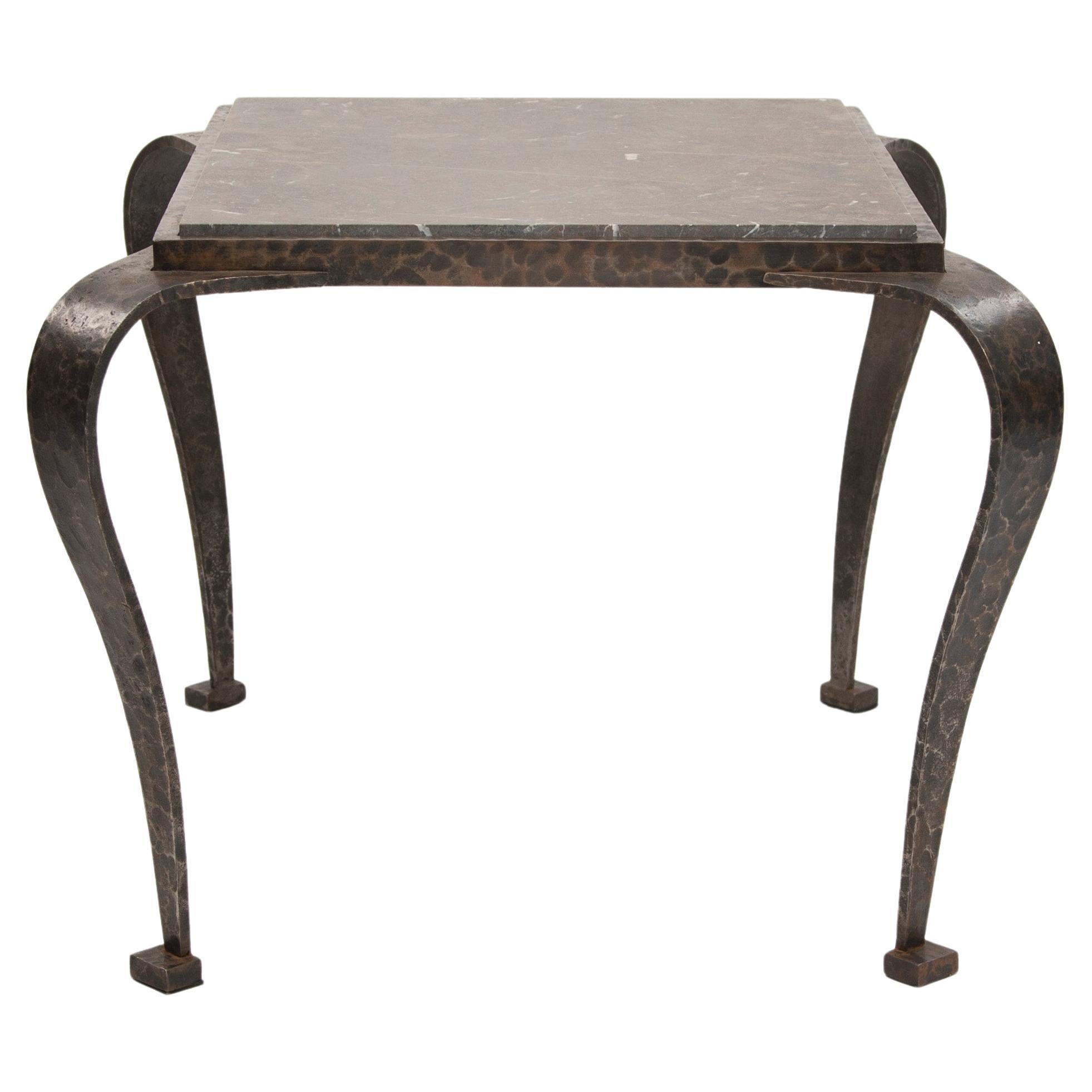 Impressive Art Deco sofa table/side table made of iron with a hammered surface and gray-rust-colored marble top.
The legs are exaggeratedly flared and then converge again, giving the heavy iron table a certain lightness despite the heavy