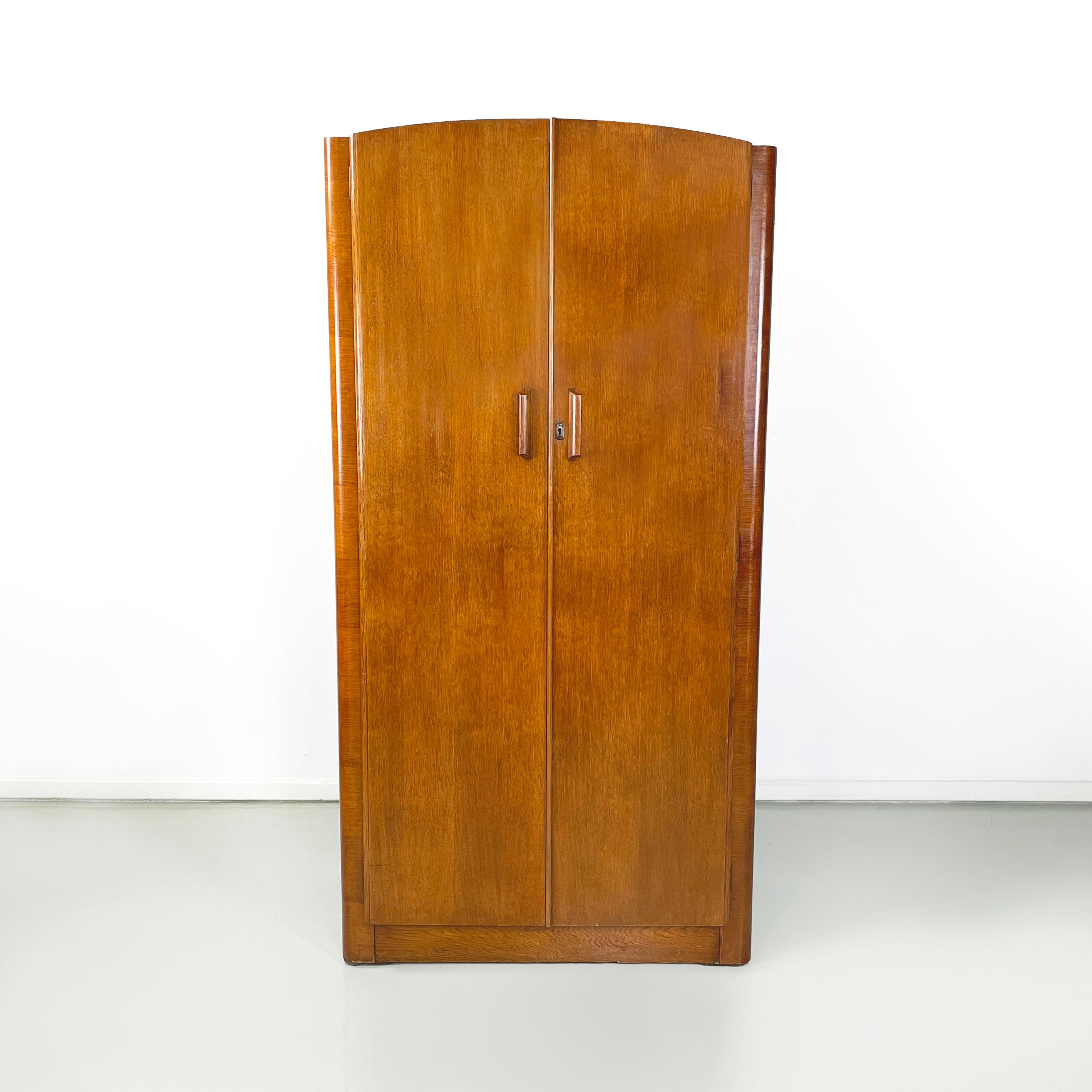 Italian art deco style Wooden wardrobe with mirror and shelves, 1950s
Wardrobe entirely in solid wood with double hinged door. Inside there are two spaces. On the left there is an extractable metal coat hanger with a wooden rod for ties. On the
