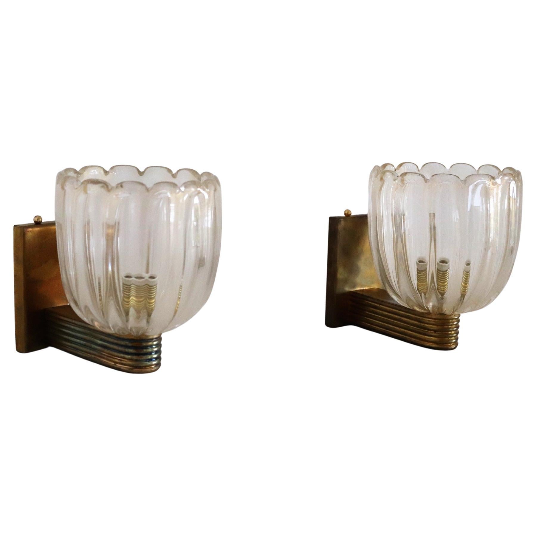 Beautiful set of two gorgeous brass wall lamps made of strong brass base and light amber-yellow glasses with golden shimmer/glitter inside the glass.
Art Deco style.
The brass is with gorgeous dark patina, the lights have been checked and