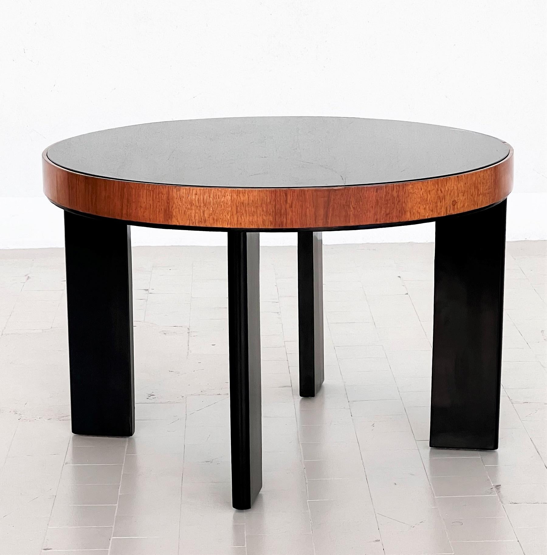 Beautiful coffee table or side table in the style of Art Deco, beginning of the 20th century.
Made in Italy circa in the 1970s.
The table legs are made of a solid wooden base lacquered in black color.
The round border around the table is made of