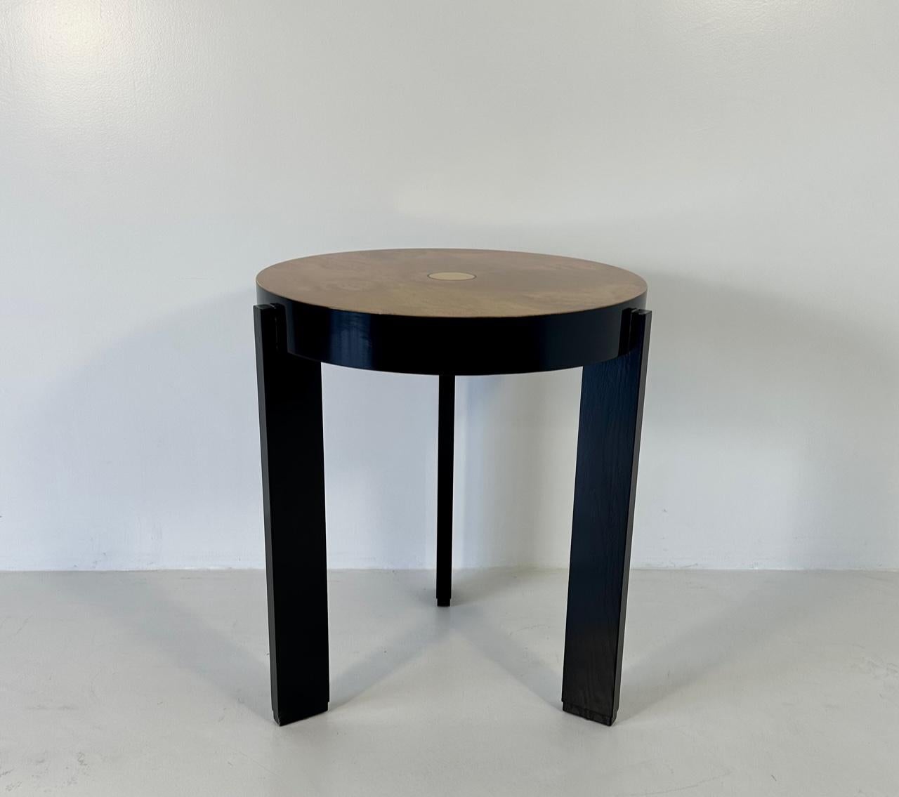 This coffee table was produced in Italy in the 1980s. 
The three legs and the edge of the top are black lacquered, the top is in maple burl, while the decoration in the middle of the top is a gold leafed circle. 
Completely restored.