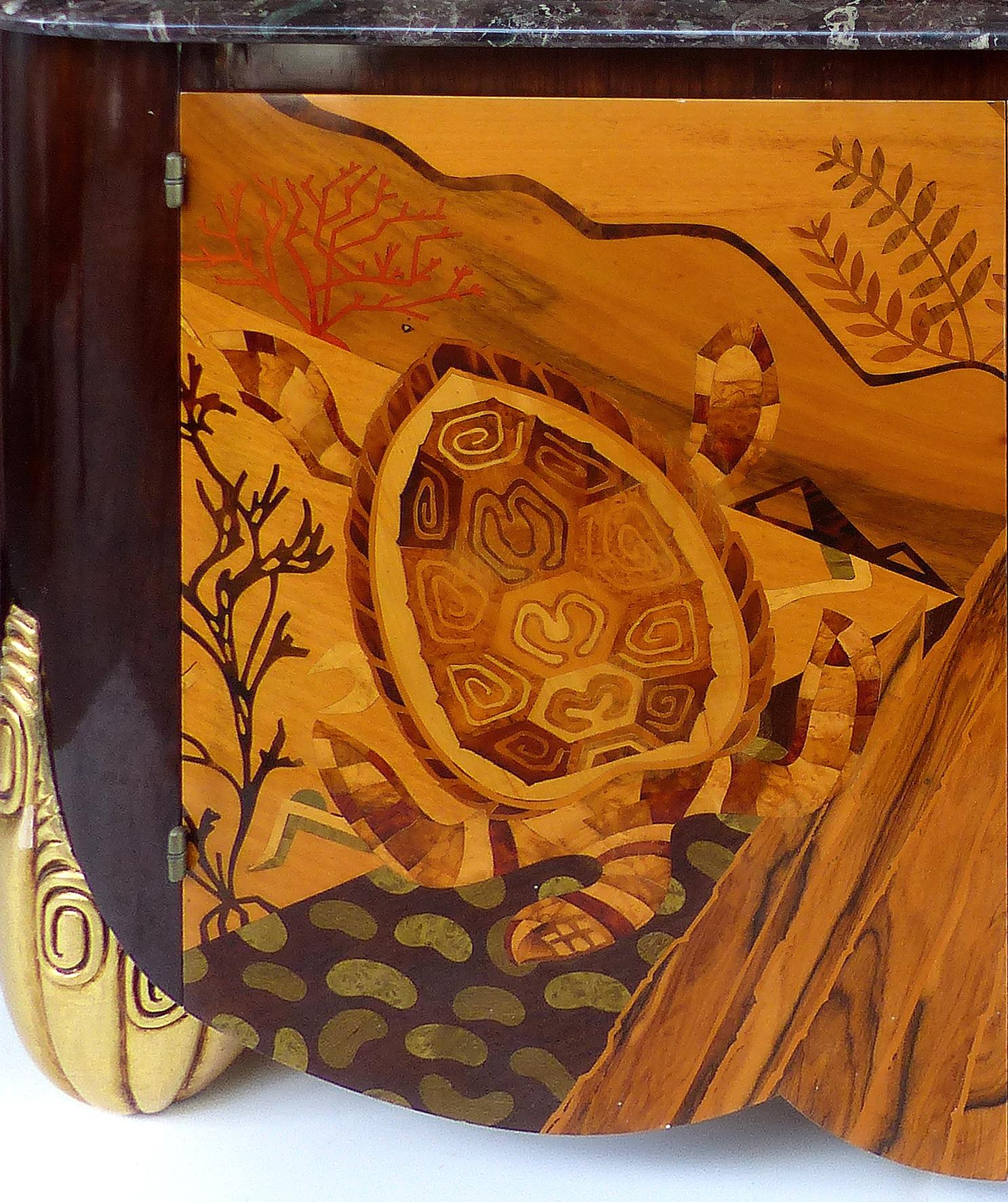 Italian Art Deco Style Marble-Top Cabinet with Marquetry of Sea Turtles

An Art Deco style marble-top two-door cabinet. The two doors have intricate marquetry depicting an underwater scene with sea turtles and coral. This cabinet is in the style of