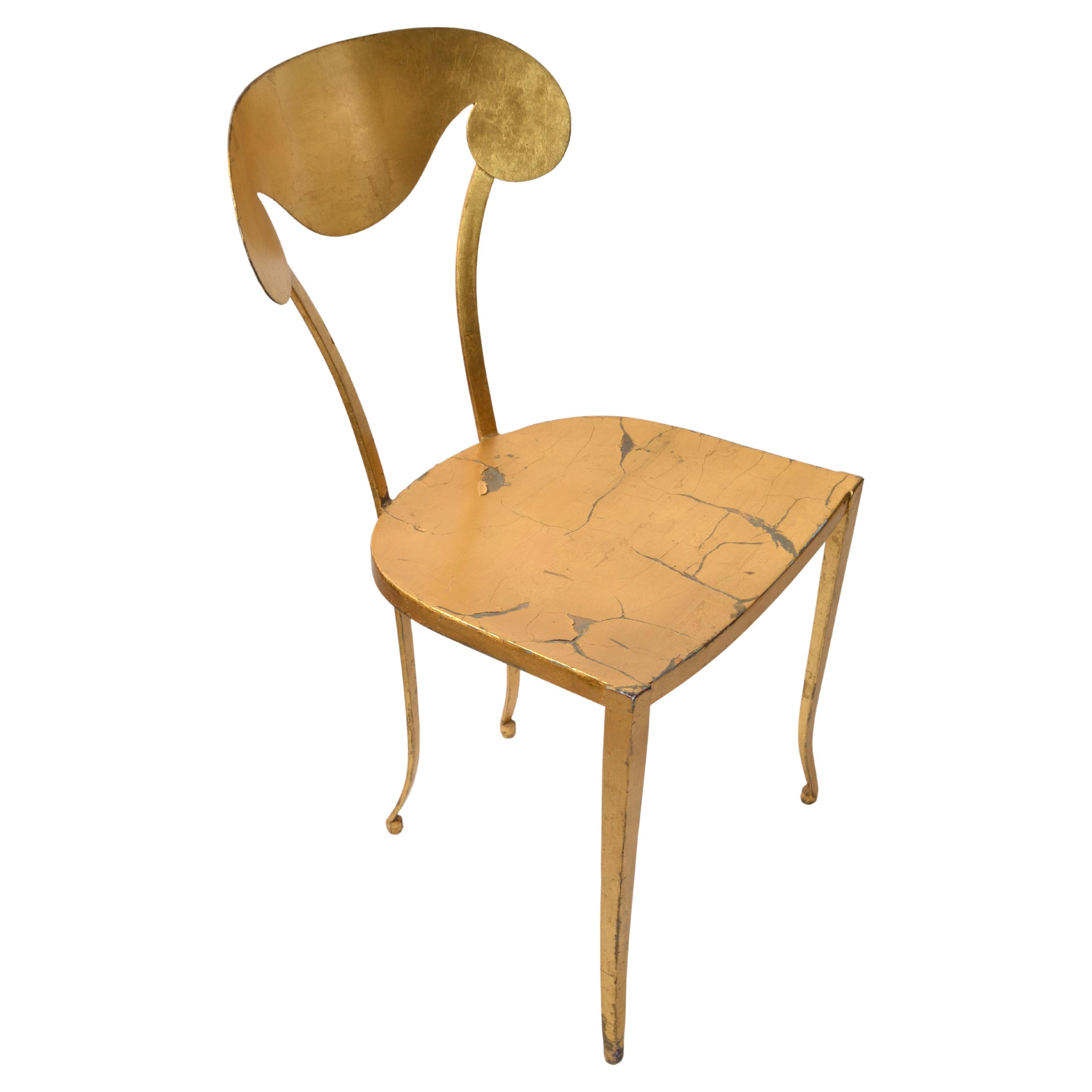 Artistic Italian Art Deco Style hand painted and handcrafted gold leaf Steel vanity, side or desk chair in distressed golden finish. 
Sculptural shaped backrest and legs makes this Side Chair very elegant.
Even though it is a steel chair it is