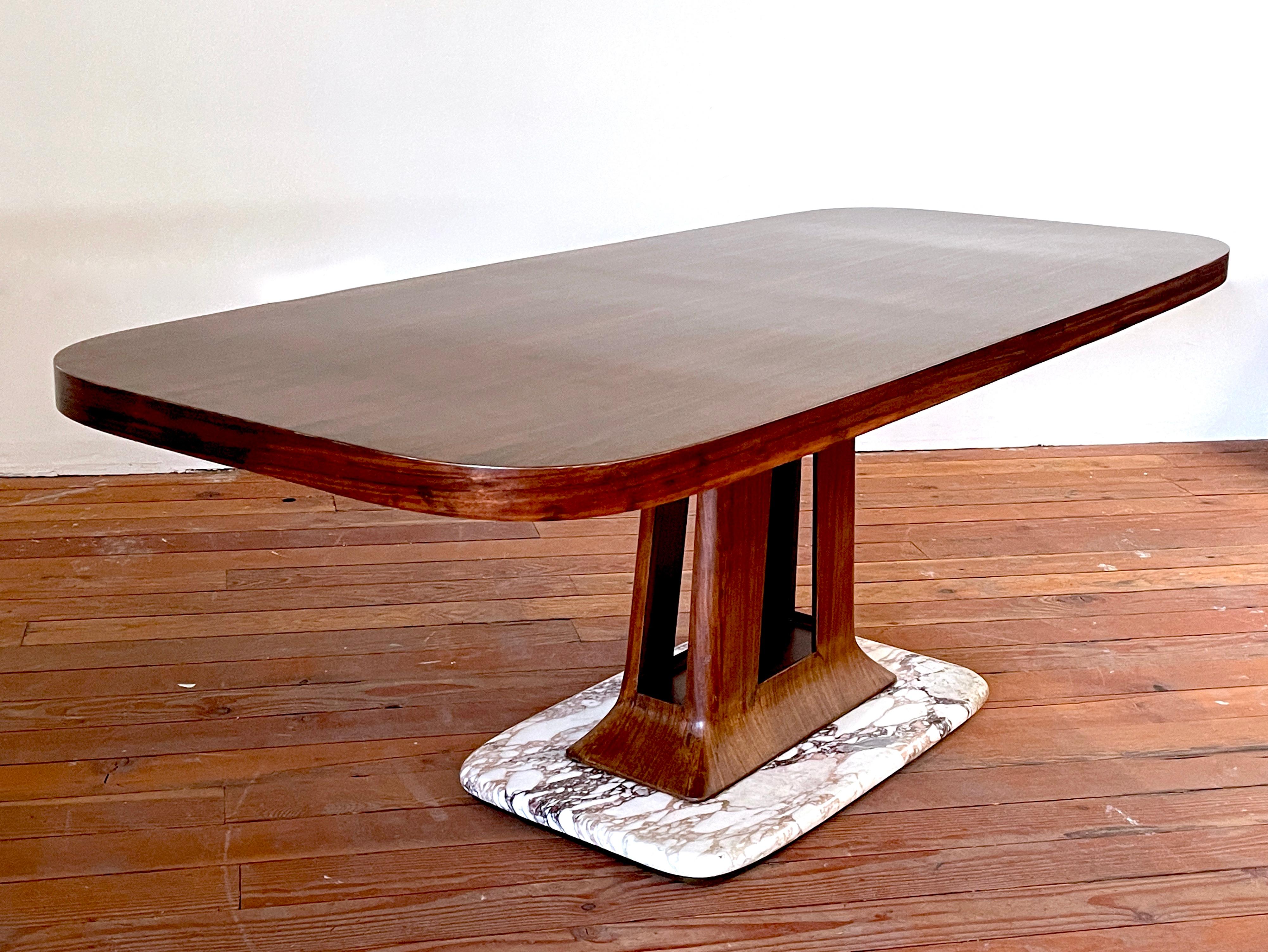 Incredible Art Deco rosewood dining or center table with sculpted rosewood pedestal and marble base. 
Newly refinished and restored. 
Gorgeous piece.