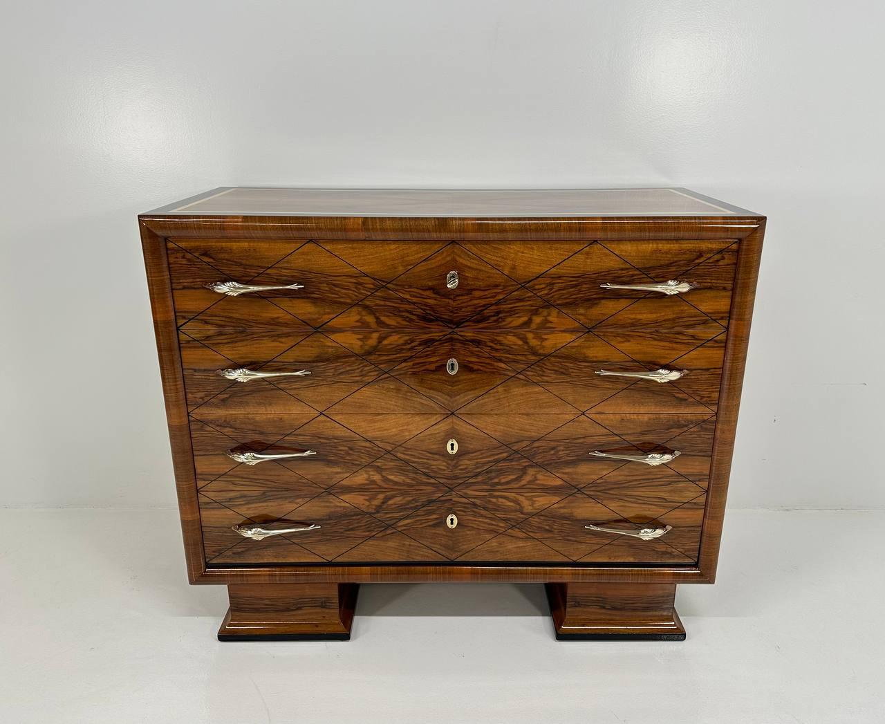 This Art Deco dresser was produced in Italy in the 1940s.
It is completely made of walnut briar with black lacquered geometric decorative lines on the drawers and two profiles, one black lacquered and one gold leafed, on the top. 
The handles and