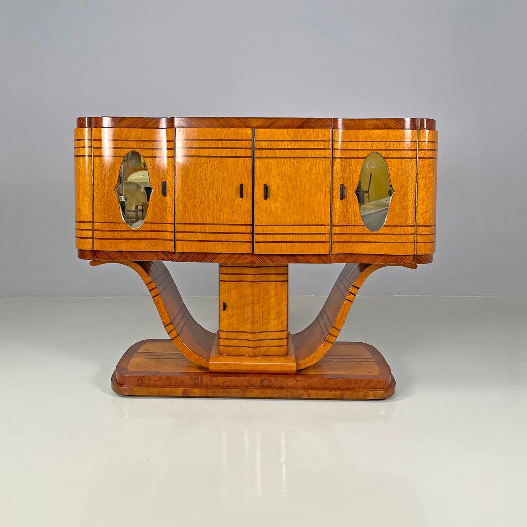 Italian Art Deco wooden bar cabinet mirrored doors and decorative inlays, 1930s
Bar cabinet, sideboard or credenza in wood. The top is rectangular and elongated with rounded corners, the front has five doors: two external ones with mirrors that open