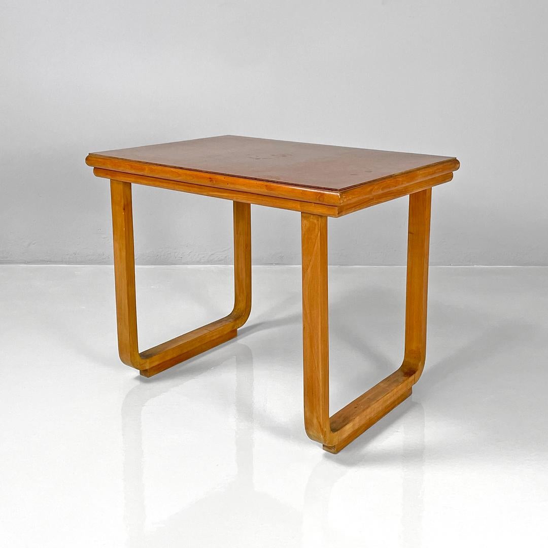Italian Art Deco wooden coffee table, 1940s
Coffee table with rectangular top made entirely of wood. The top has shaped sides, the two side legs have a rectangular section and have a 