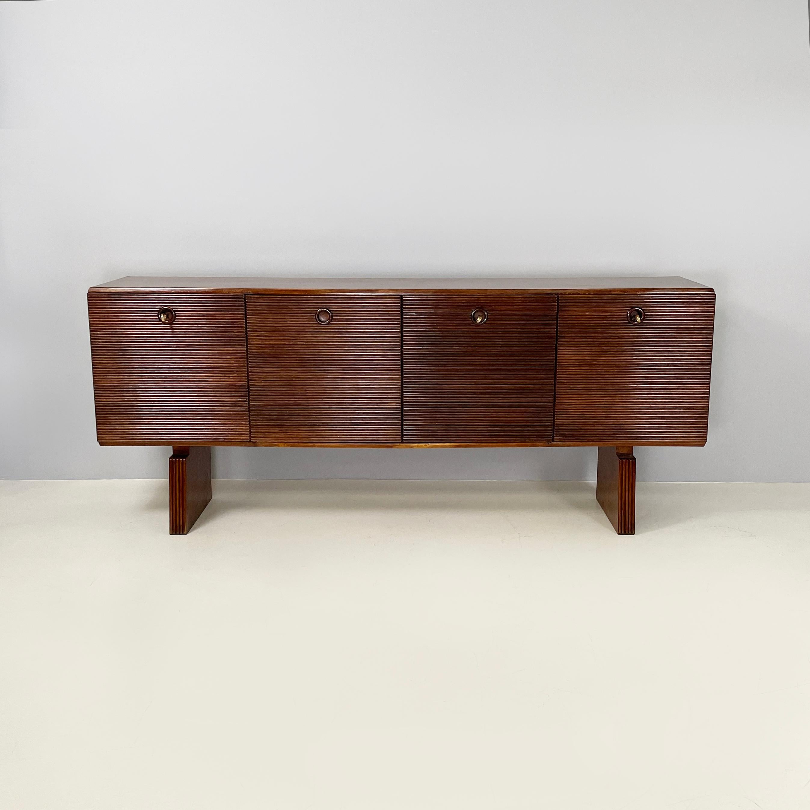 Italian Art Deco wooden sideboard with four doors by Gio Ponti, 1940s 
Sideboard with rectangular wooden top. It has four striped wood doors, each with a hole with a turned wooden frame that acts as a handle. Three out of four doors have working