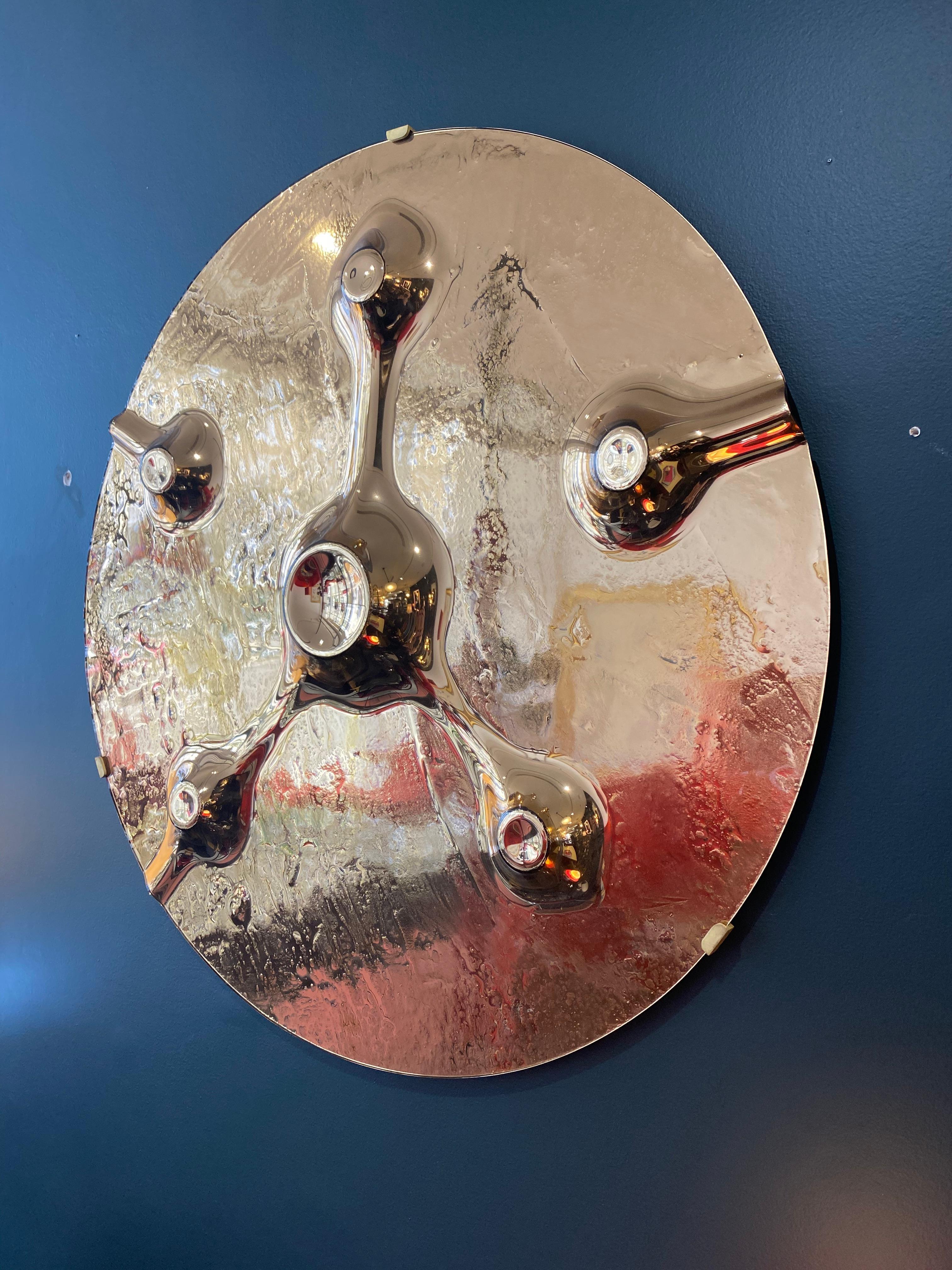 A circular handcrafted art glass depicting a Martian landscape with intricate details in copper mirrored glass. This is part of a series designed uniquely for RKade Studio.



 