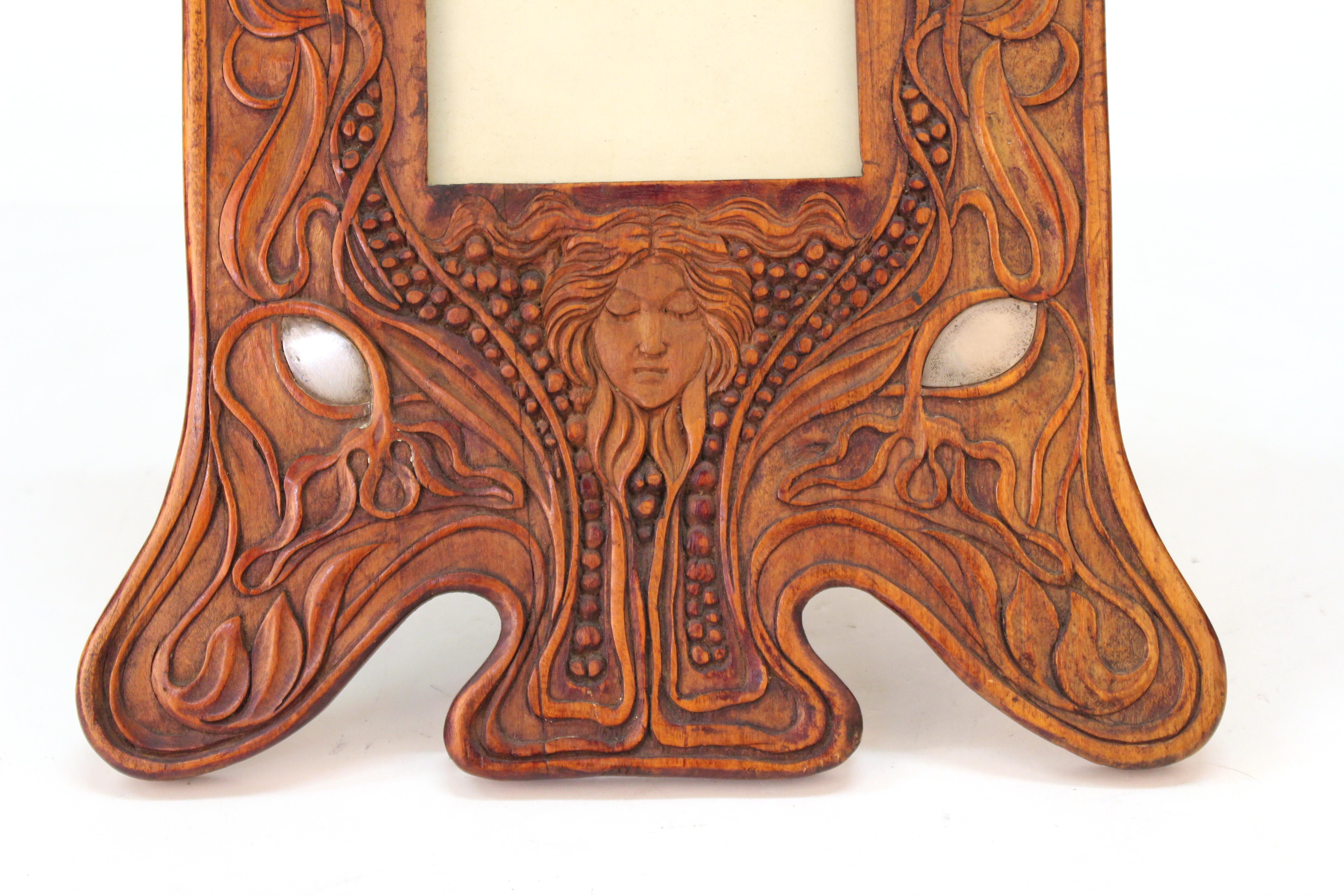 Italian Art Nouveau picture frame attributed to Carlo Zen, richly carved in fruit-wood with silver inlays and a fruit-wood back leg. The piece was created in Italy circa 1900 and is in great vintage condition with some age-related wear to the wood.