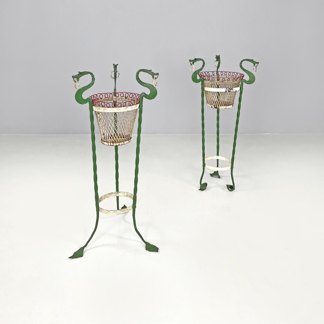 Italian Art Nouveau white green wrought iron vase holders with dragons, 1900s
Pair of wrought iron vase holders. The two structures are both composed of three twisted iron bars painted green and ending with leaf-shaped feet, but they differ in the