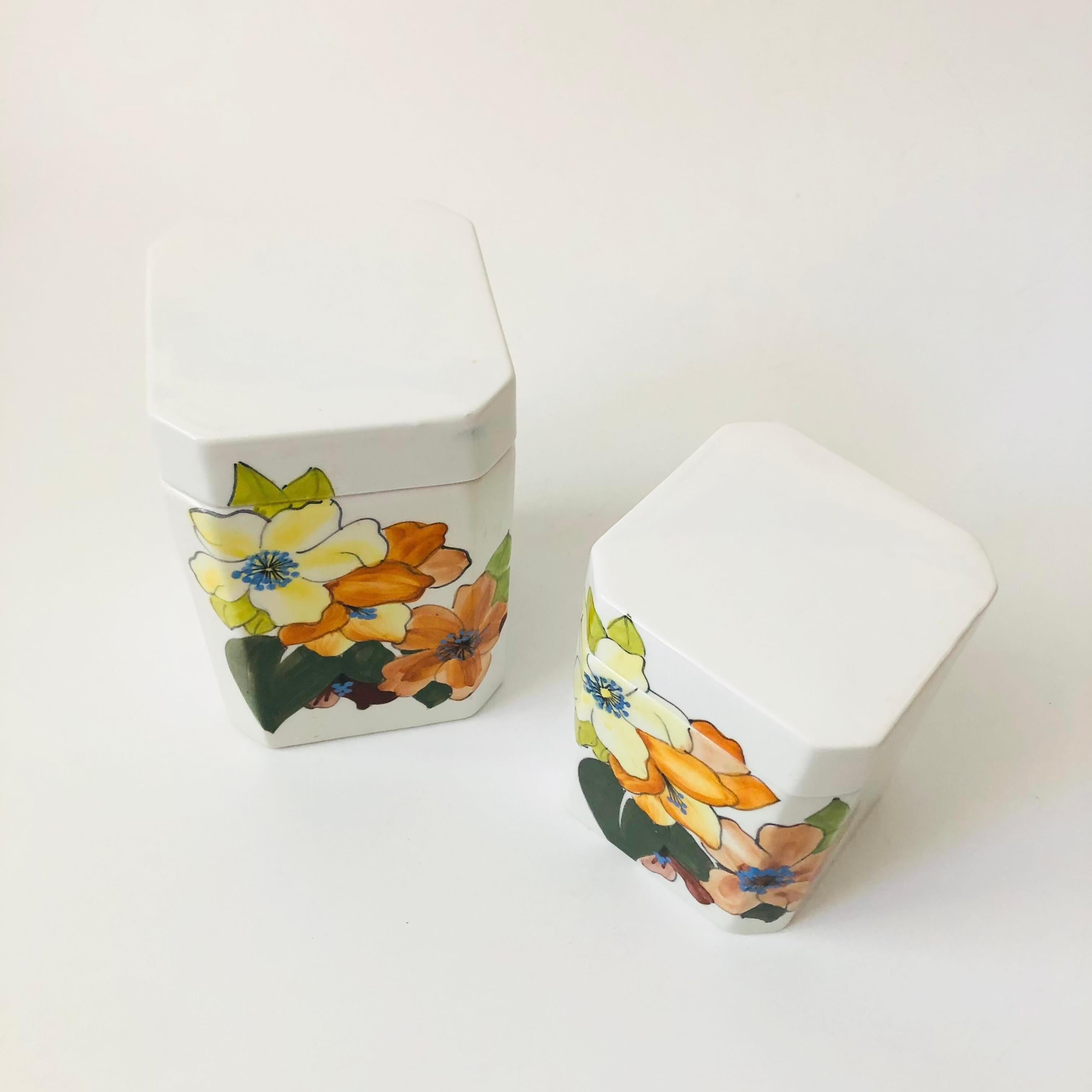 A set of 2 vintage art pottery kitchen canisters, made in Italy by Cossa. Decorated with beautiful hand painted floral designs. Each is marked and numbered on the base.
Measurements:
4.25