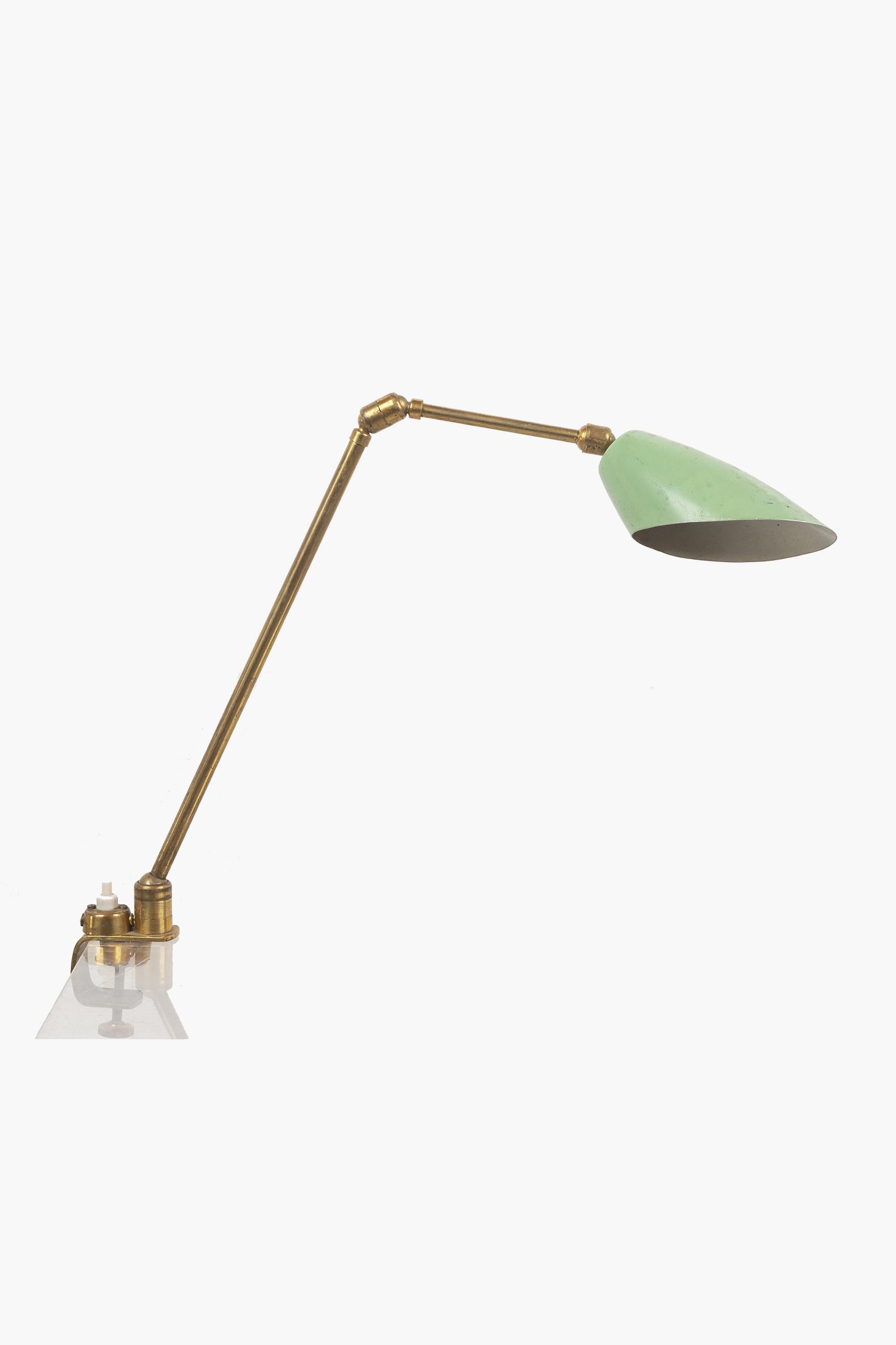 An unusual articulated desk lamp with clamp fitting that allows the light to be attached to a desk or shelf.

In good original condition, with nicely patinated brass and original duck egg blue painted shade.

Can be wired to specification. The