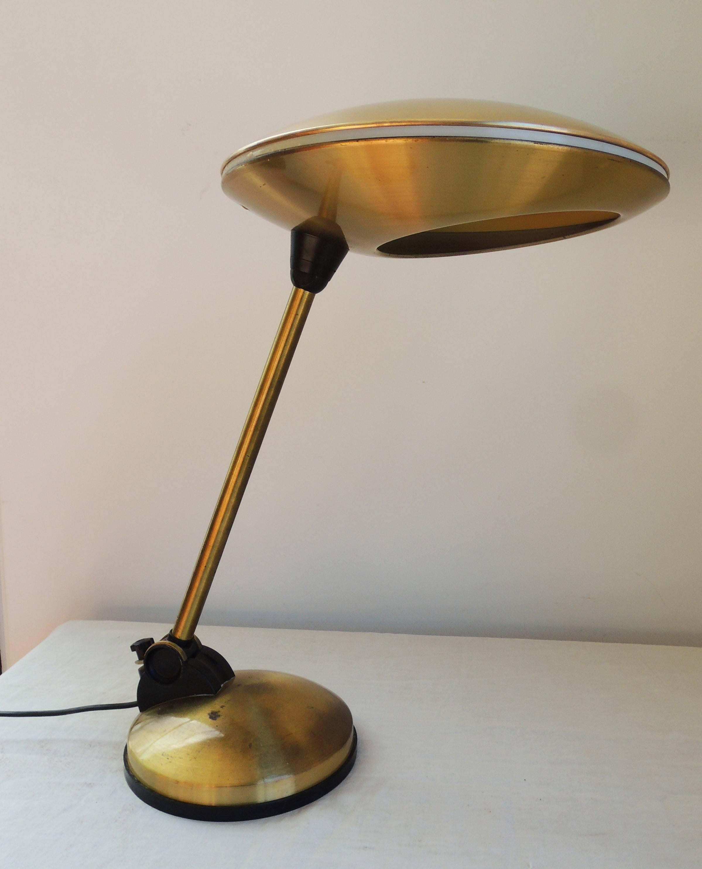 Cool flying saucer articulated table lamp of brass and black plastic.
The brass has a warm patina. Distinctive and unusual.
Not marked. Originally European wiring. (rewired.)
The top disc is 34 cm. The bottom disc is 20 cm.