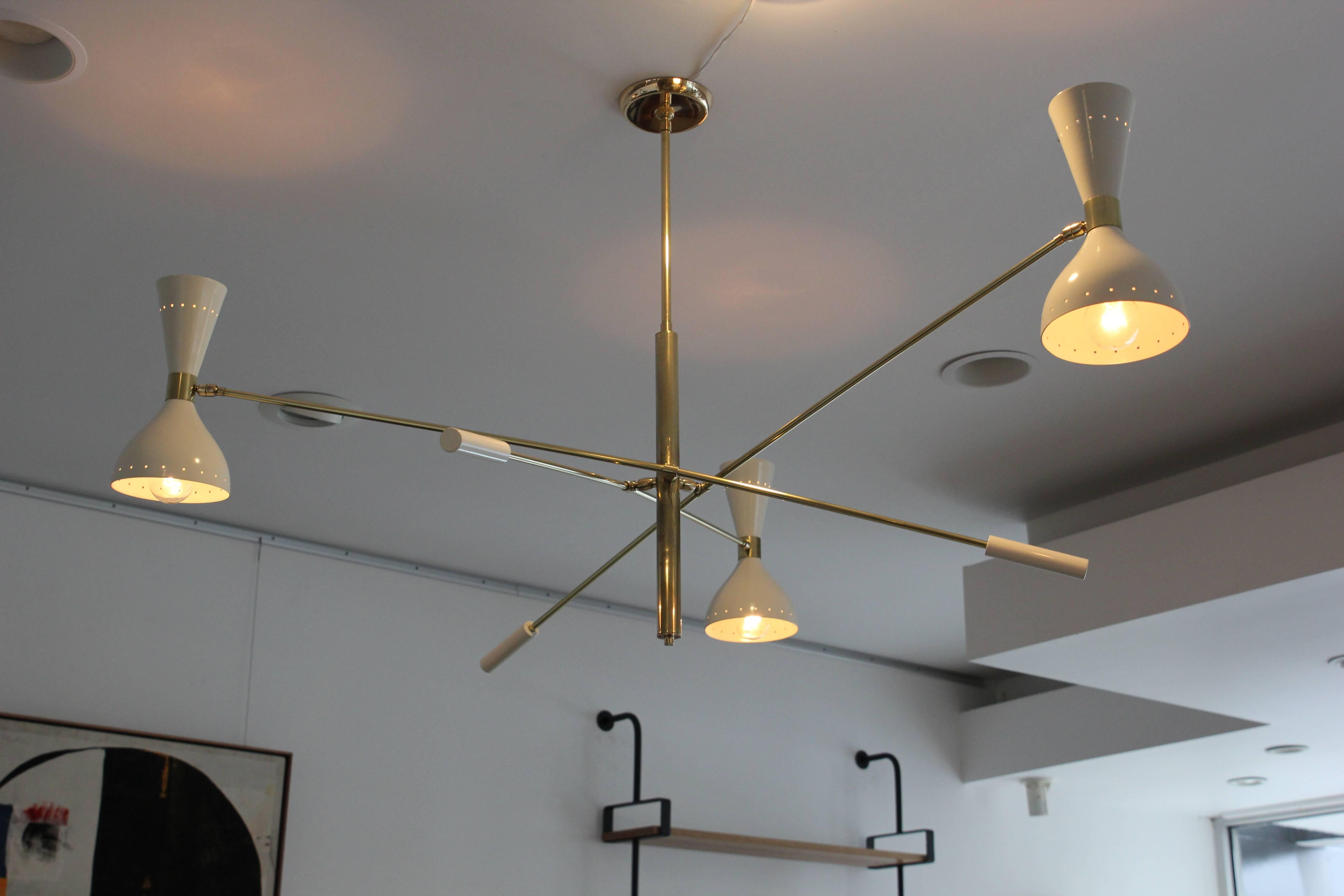 Large-scale three-armed ceiling light in style of Stilnovo with white cone articulating shades and brass arms.
Newly produced in Italy and newly rewired.