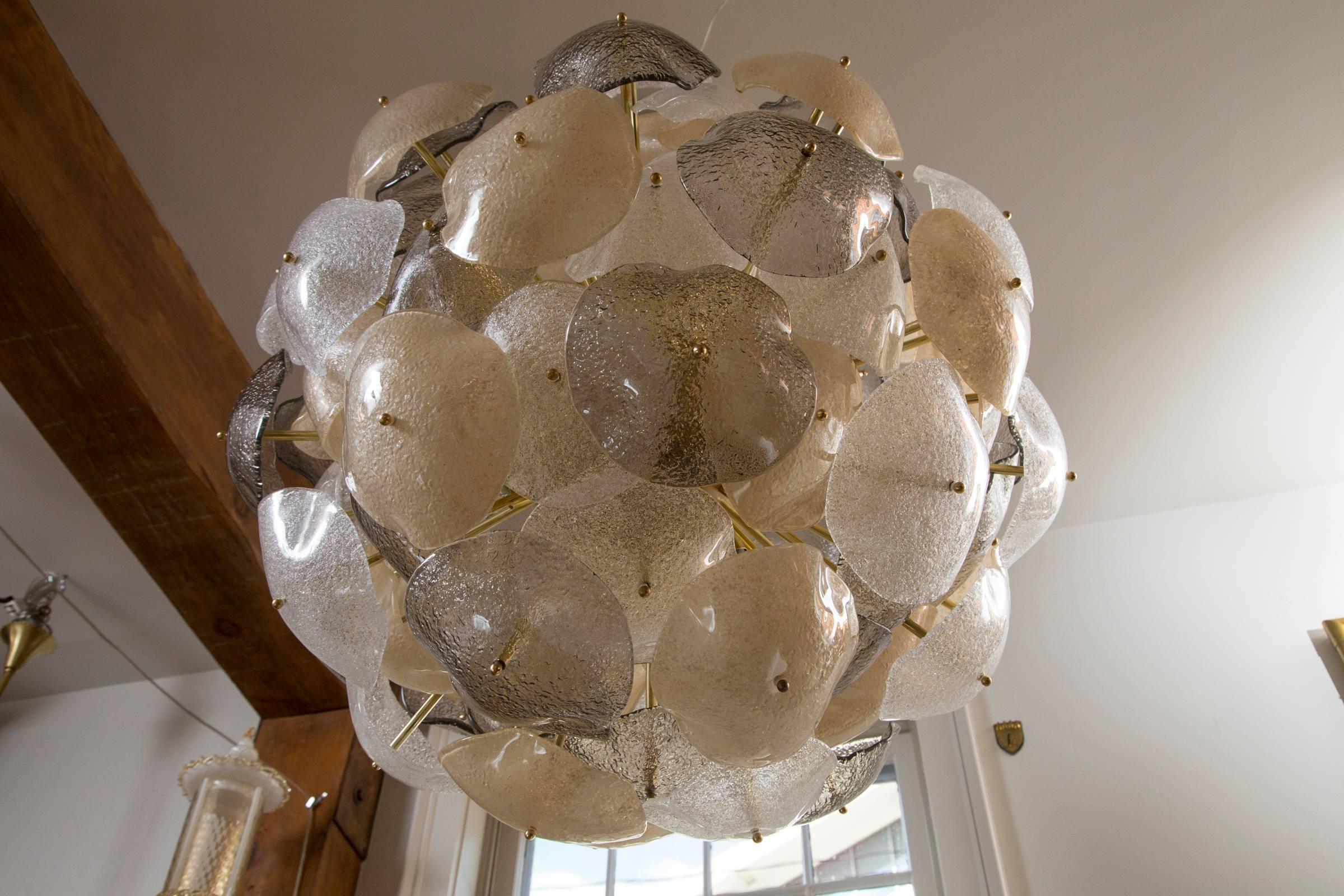  Murano Orb chandelier comprised of  96 blown organic shaped disks in three tones of icy white, warm smoke and cool grey
electrified to illuminate 18 medium base bulbs (only partially illuminated in the photos)

Origin: Venice
Dating: Newly