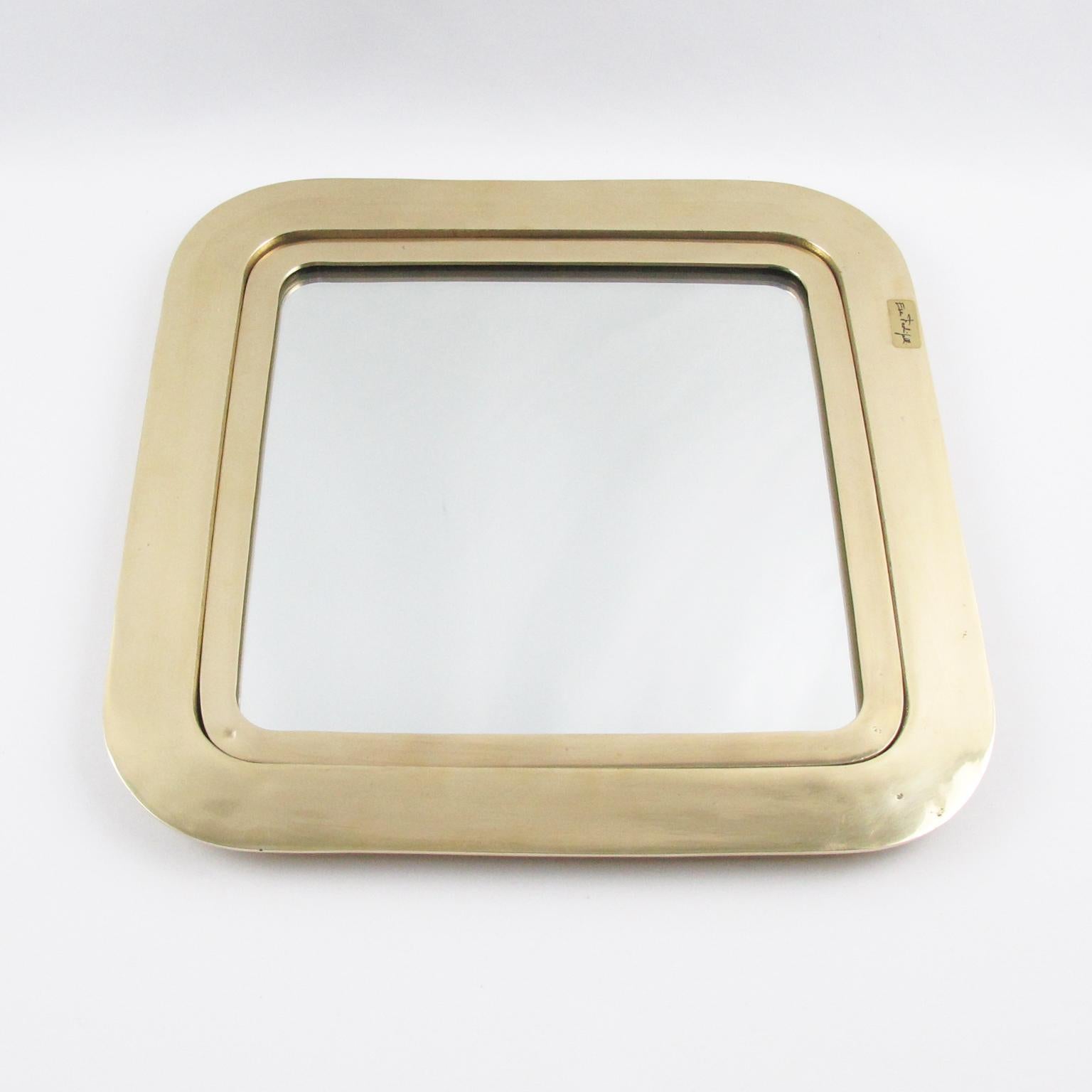 Italian artist Esa Fedrigolli crafted this impressive polished gilded bronze centerpiece tray, platter, or vide poche. The piece features a heavy square shape with rounded corners and a mirror insert with glass protection. The centerpiece is signed