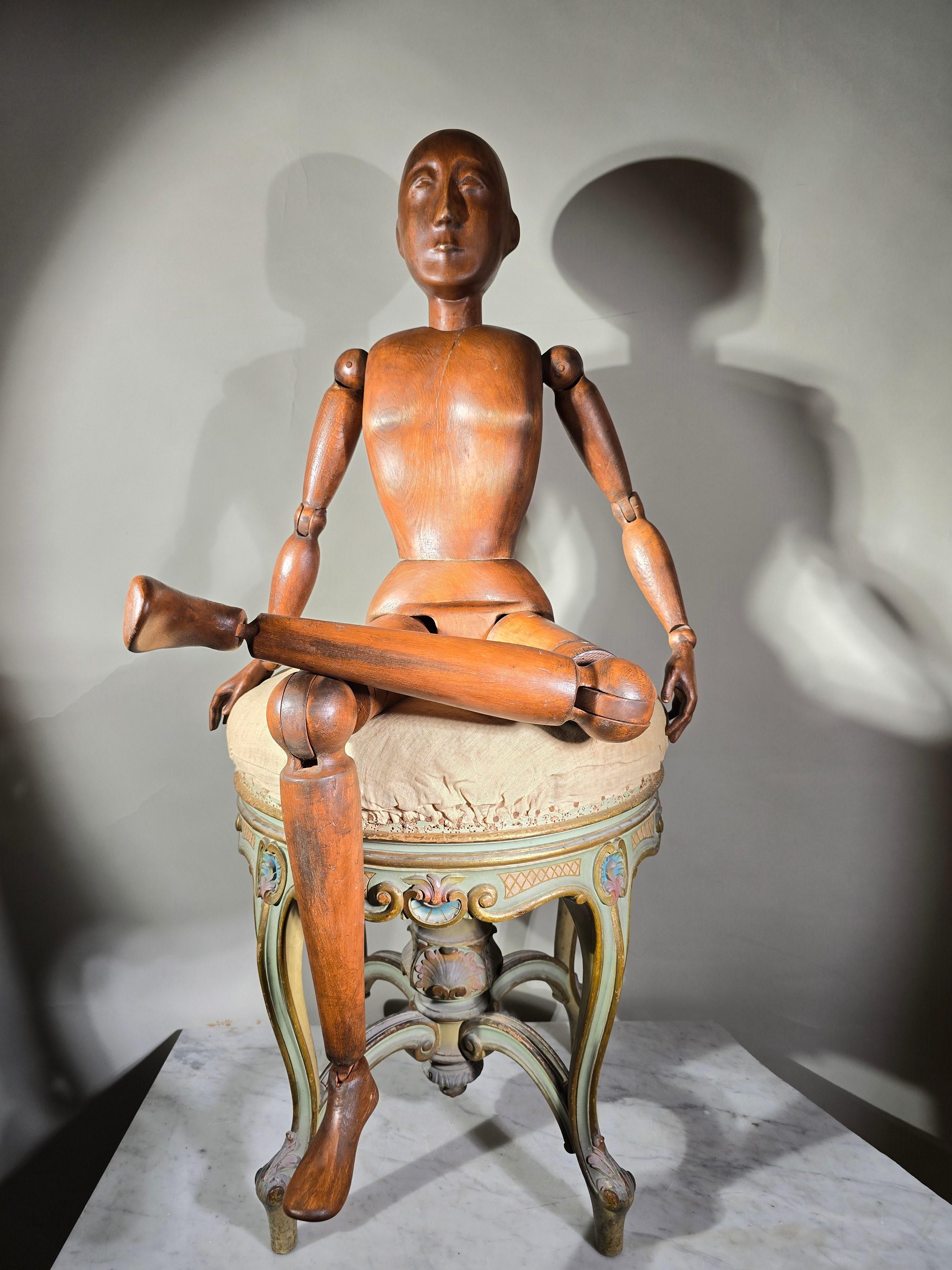 This elegant Italian artist's mannequin from approximately 1900 is a beautiful representation of craftsmanship from the 19th century. Crafted from solid fruitwood, it stands as a testament to the skill and artistry of Italian artisans of the