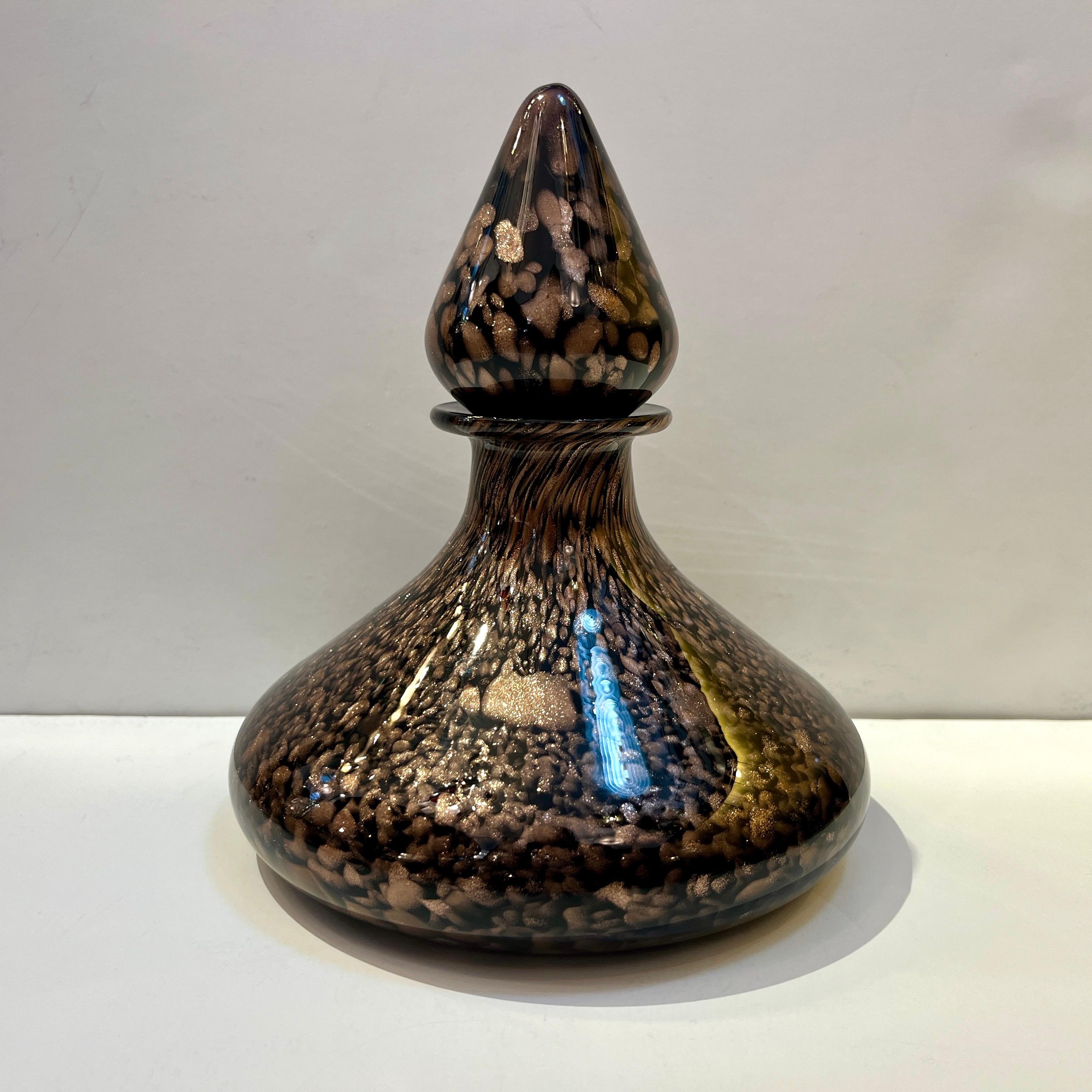 C'est un petit bijou ! Cette grande pièce d'art décoratif en verre soufflé de Murano est réalisée avec une technique de haute qualité : le corps sphérique noir de la bouteille et le bouchon sont largement recouverts de verre cristallin transparent