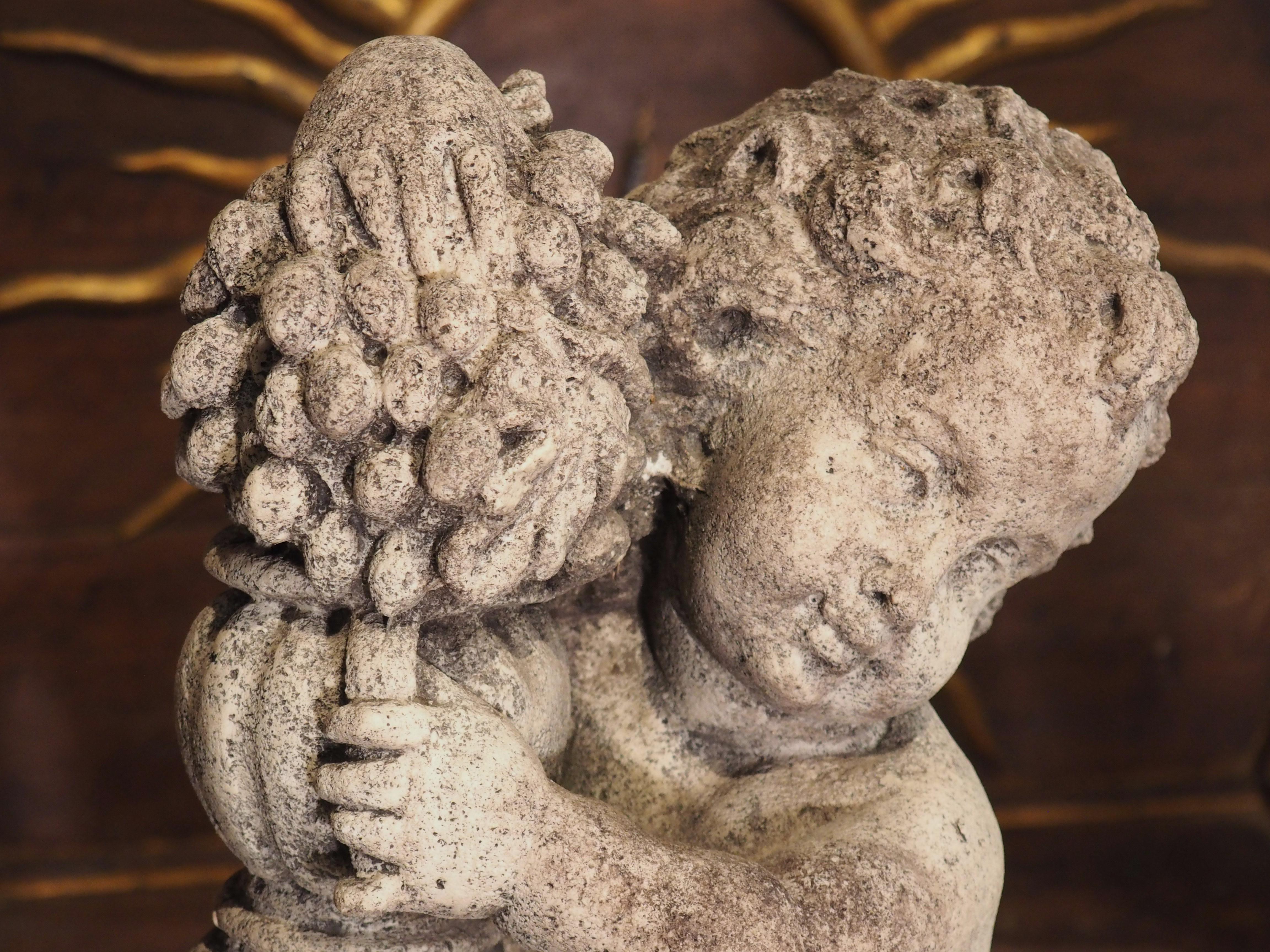 Made from cast stone in the 1900’s, this Italian statue depicts a bacchanalian putto leaning against an urn and a tree stump. As with most renderings that occurred during the Renaissance and after, our putto is depicted as a chubby male child