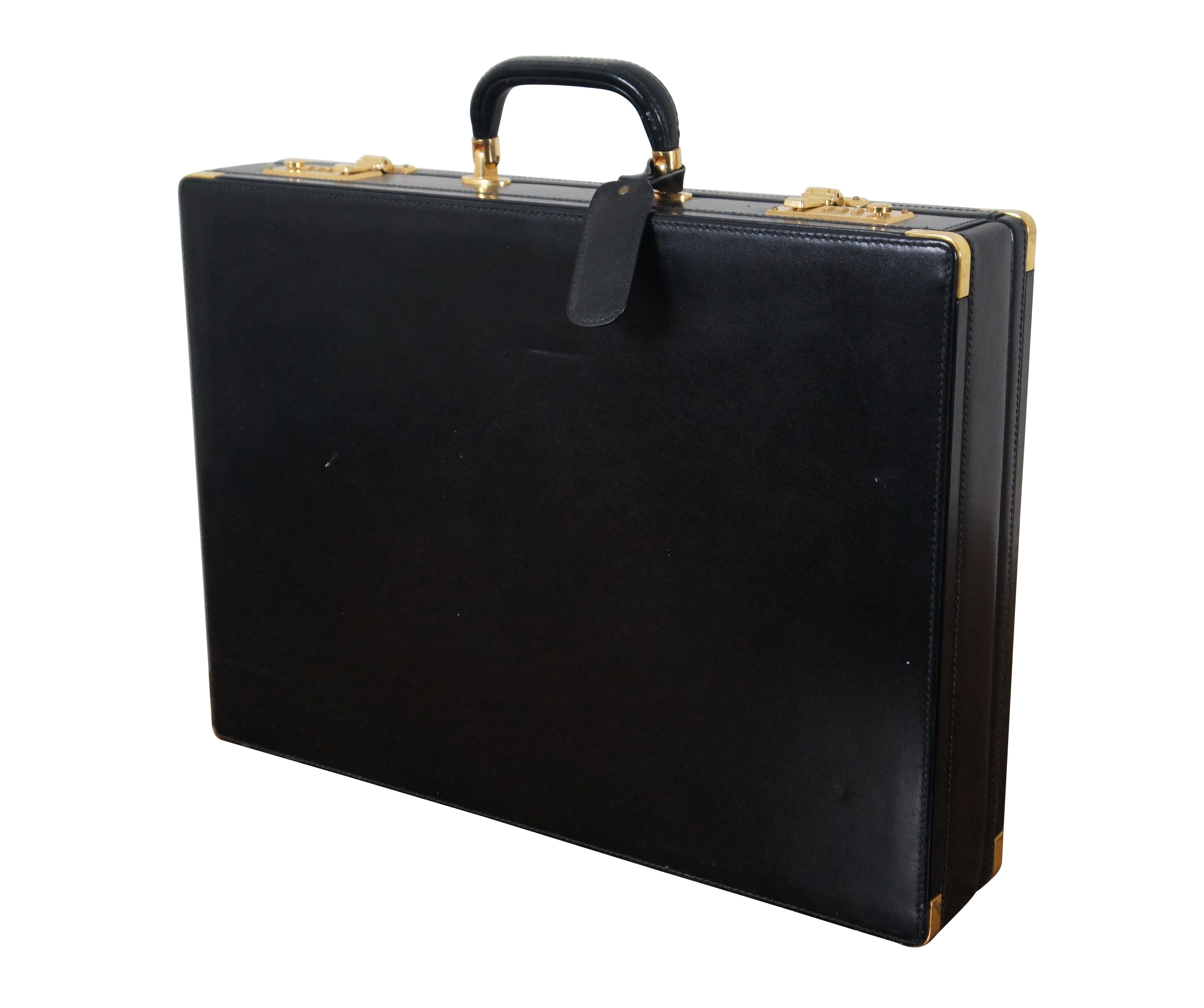 Vintage Bally black leather briefcase. Features single handle, brass feet, capped corners, and double latches with combination locks (currently set at default 000). Interior features beige suede lining, small slip pocket with removable ID card