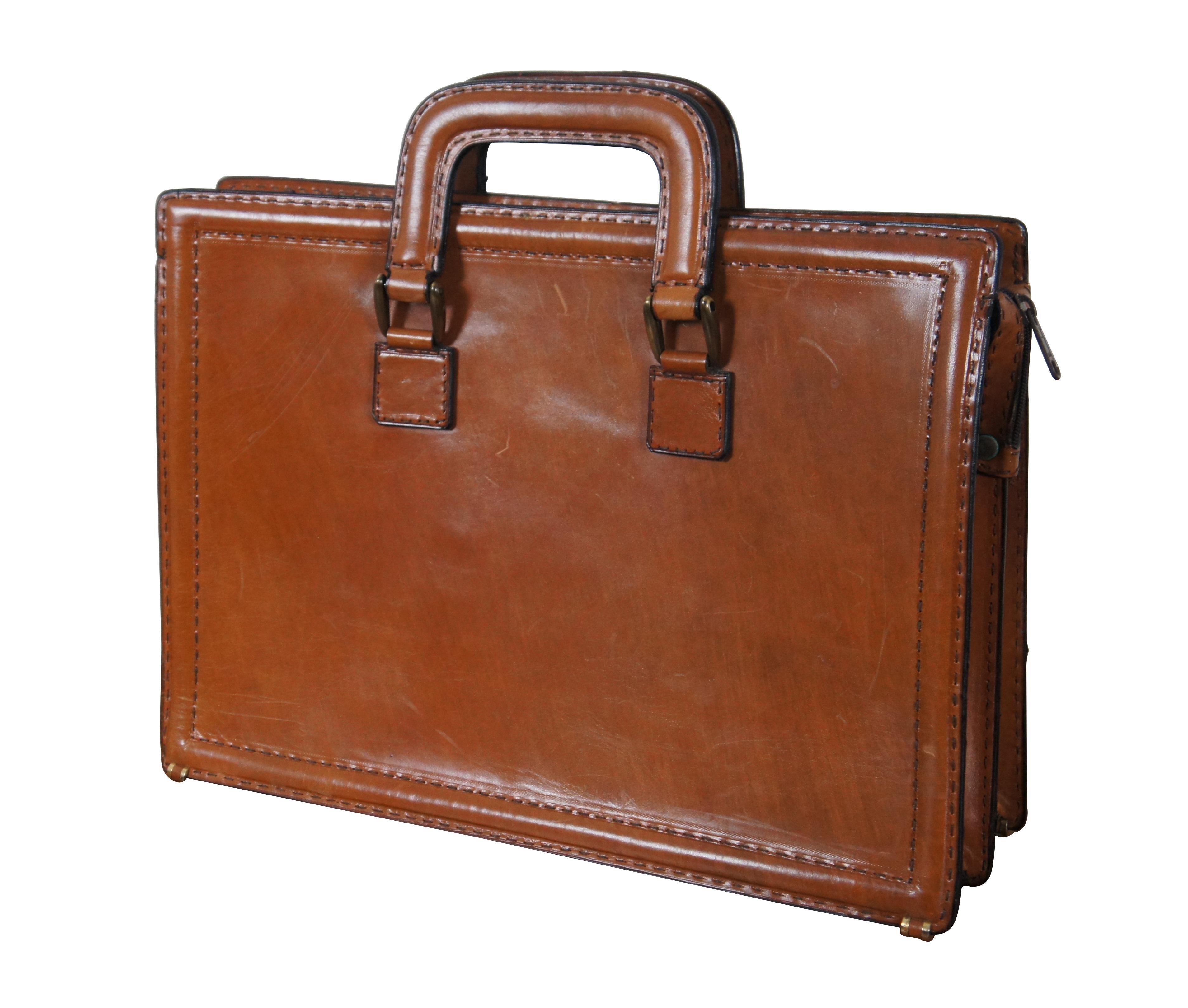 Vintage Bally brown leather attache / brief case featuring double handles, bold contrast stitching and zipper closure. Interior is divided into two open sections with a zippered pocket in the middle. Made in Italy. Includes dust bag.

Dimensions: