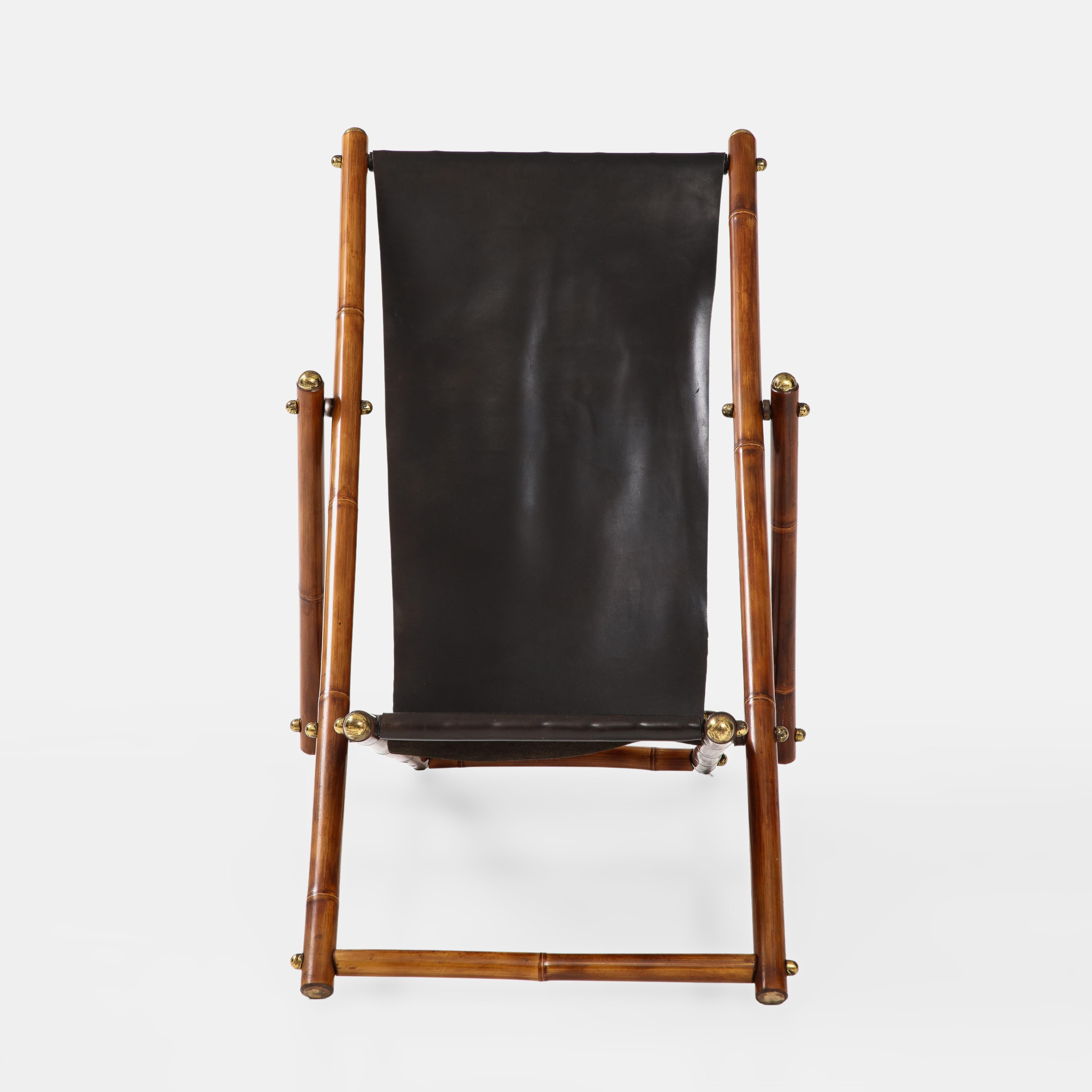 Italian adjustable reclining campaign folding chair in lacquered bamboo, original black leather sling, and brass details, 1970s.  This incredibly chic and modern campaign chair has beautiful details throughout including the architectural thick