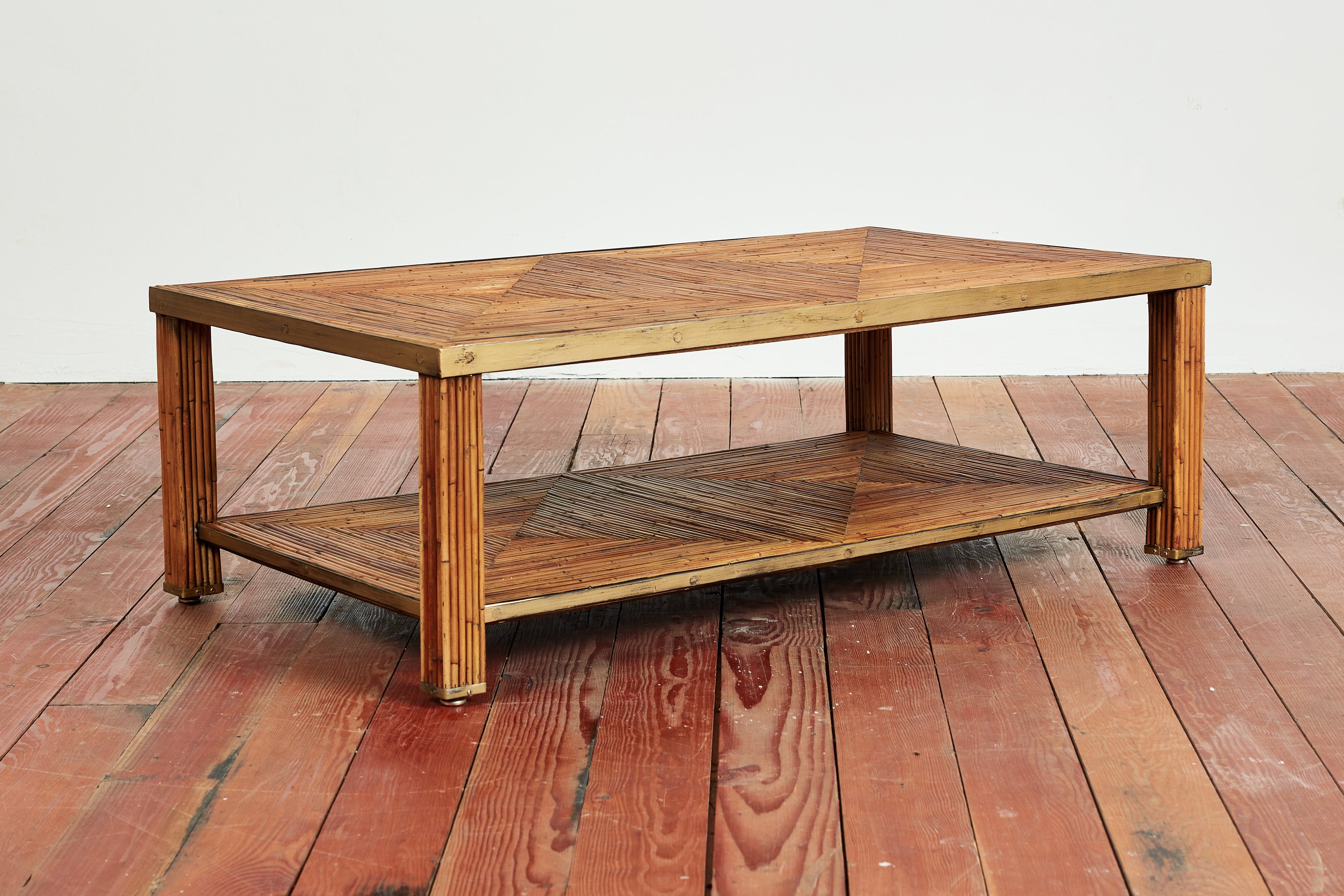 Italian bamboo coffee table with patterned top and shelf with brass edges and feet. 
Wonderful piece. 