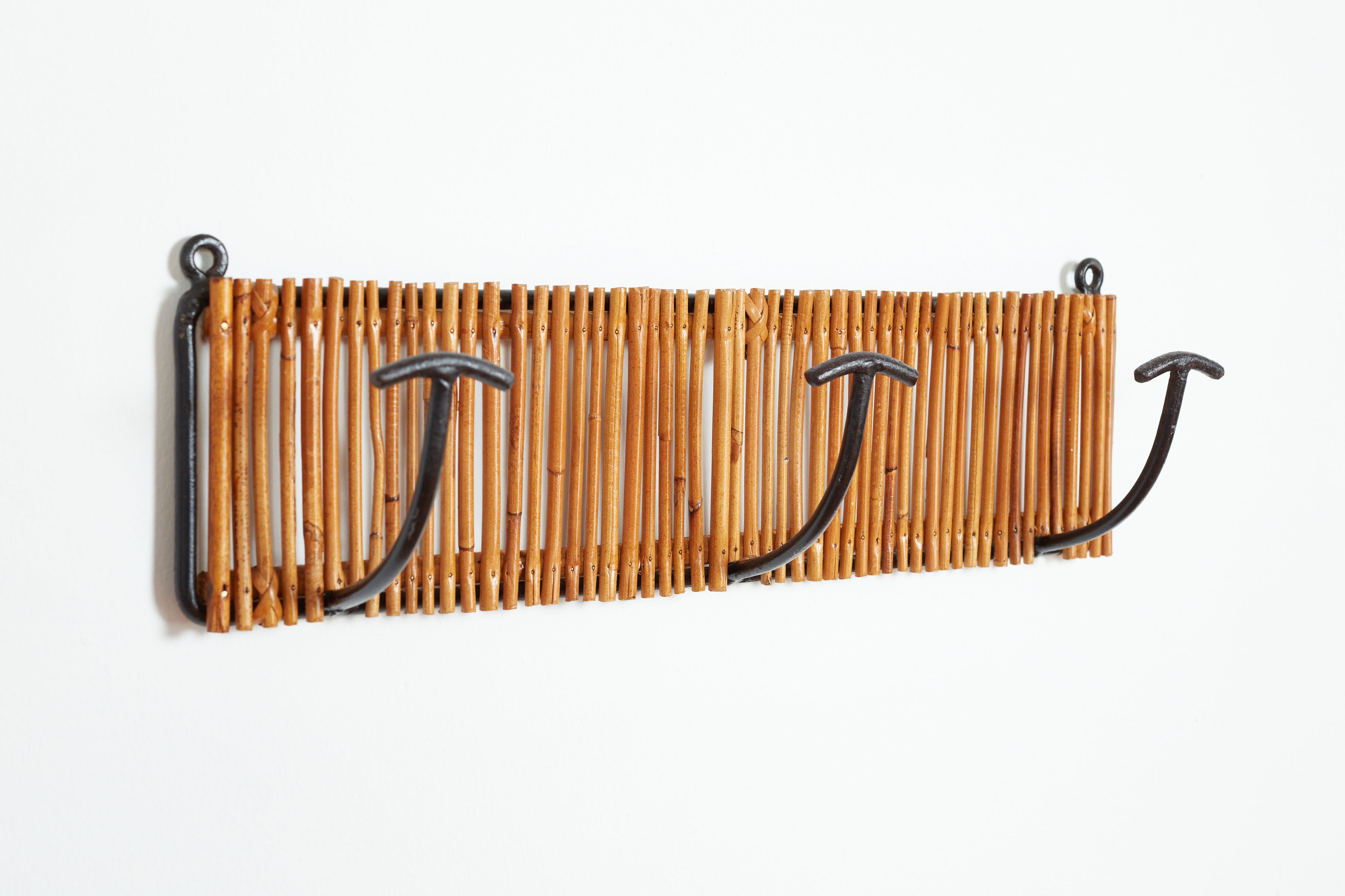 Simple Italian and iron 3 hook coatrack with forged iron wrapped in bamboo. 
Italy, 1950s