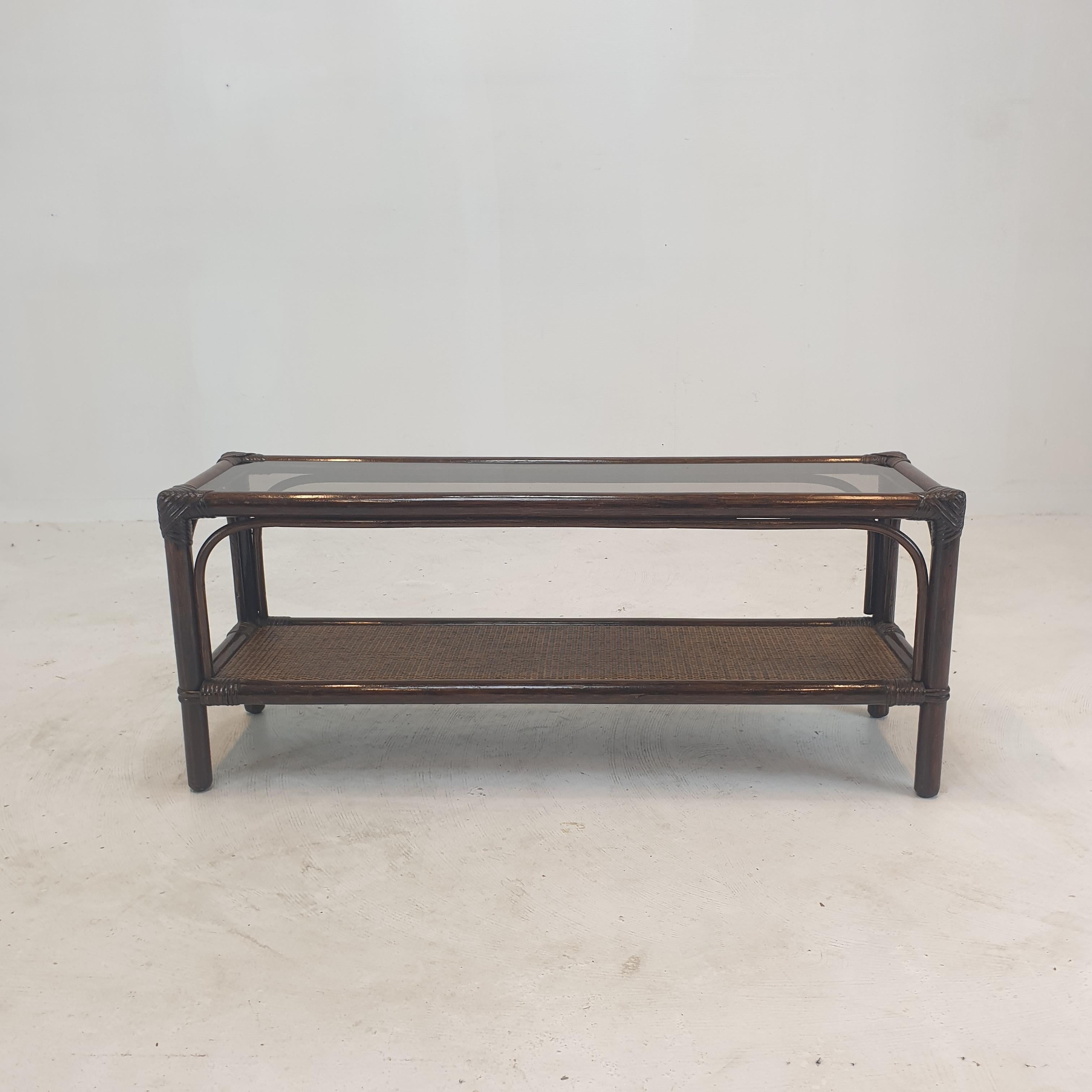 Lovely rectangle coffee or side table, fabricated in Italy in the 80's. 
This very nice table is made of bamboo and rattan.
The plate is made of smoked glass.

We work with professional packers and shippers, we can deliver worldwide within 5 to