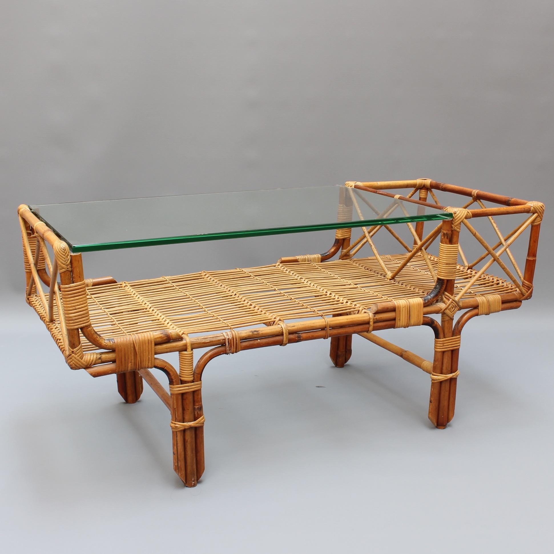 Vintage Italian bamboo and rattan glass coffee table, circa 1960s. This table combines its elements to form an incredibly stylish piece whose past effortlessly connects with today's looks. It is a sizable piece which can complement a diversity of