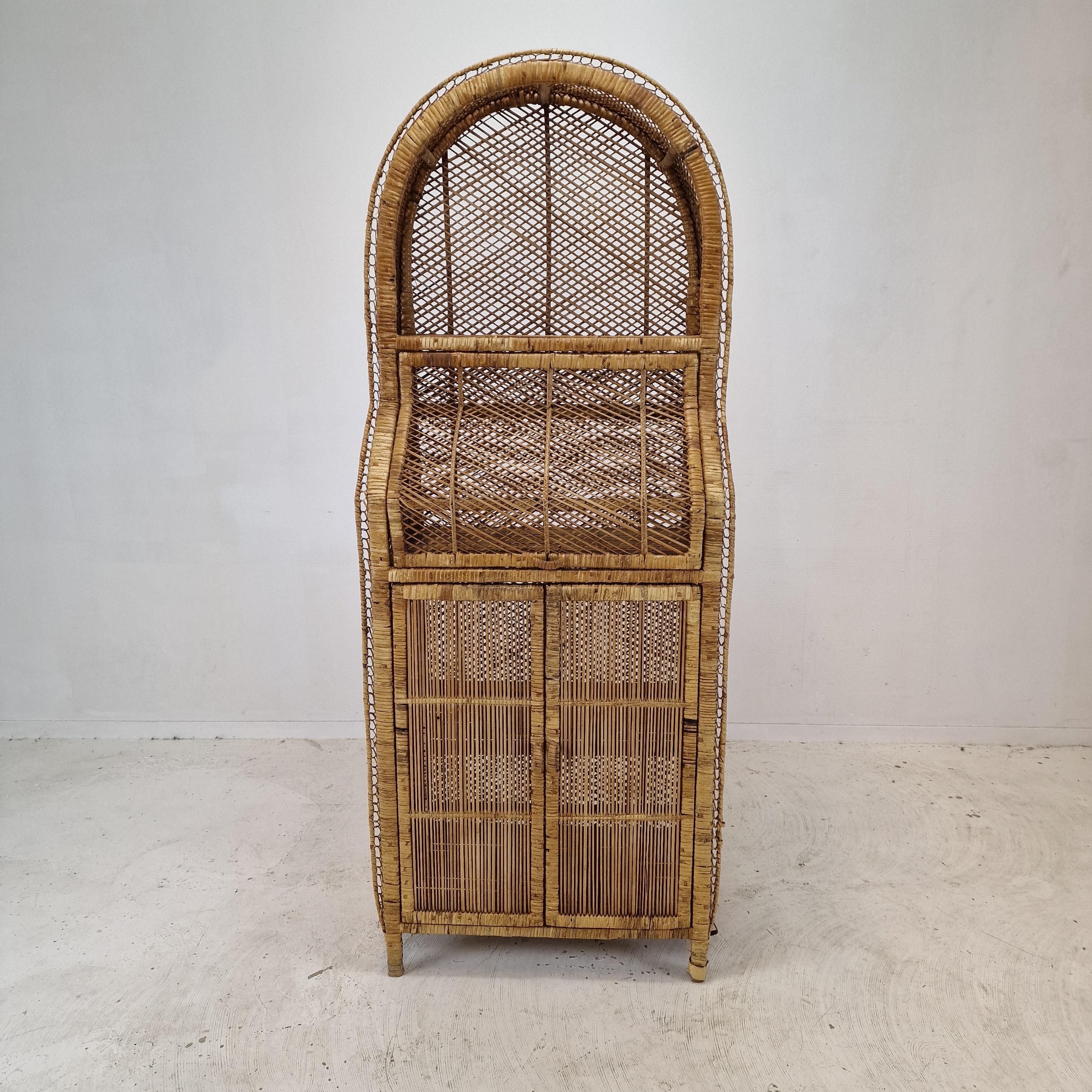 Lovely credenza or bookcase, fabricated in Italy in the 70's. 
This very nice credenza is made of bamboo and rattan.

It has two doors on the lower part and a fall flap opening in the middle part.

We work with professional packers and shippers, we