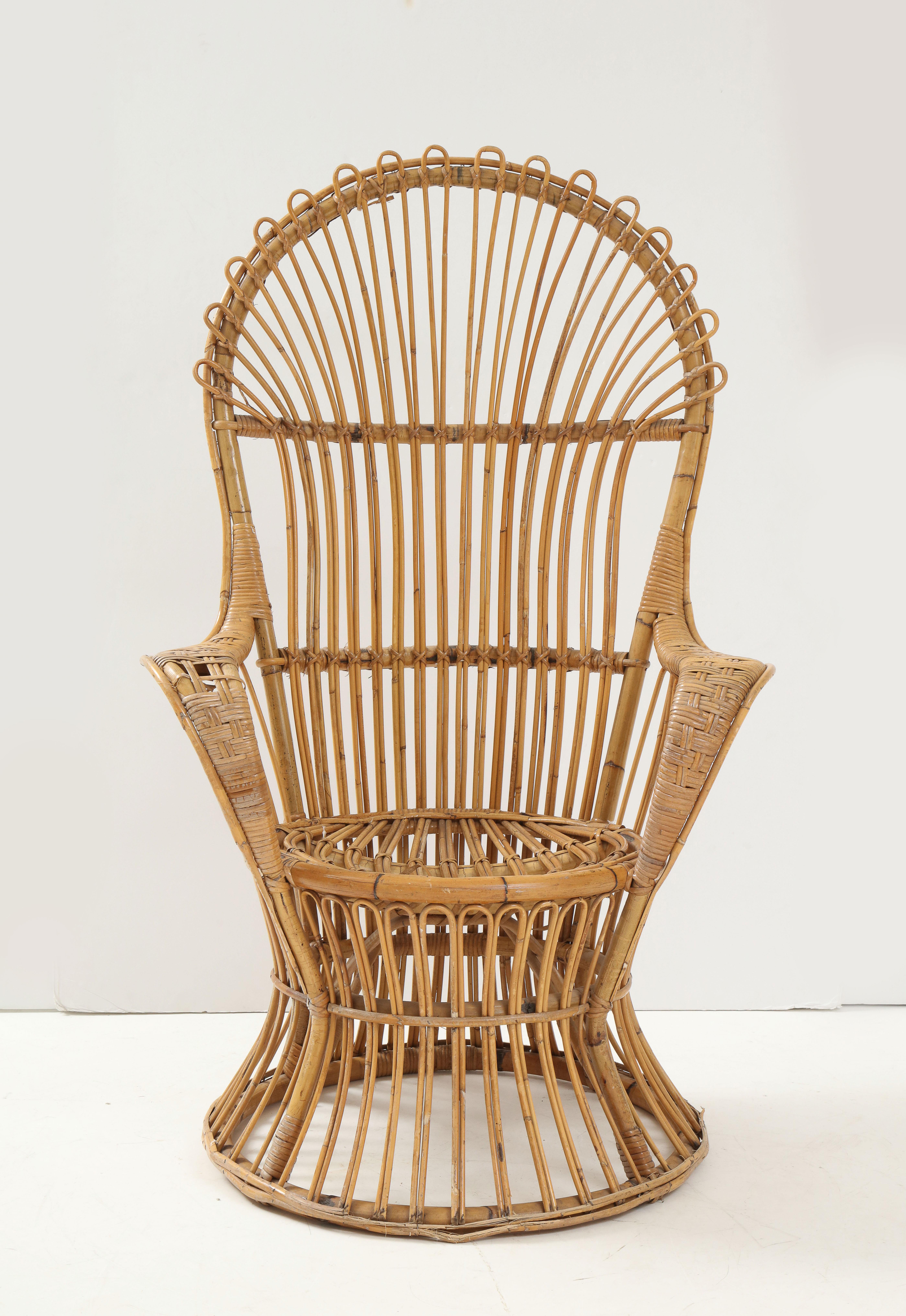 An Italian high-back bamboo and rattan armchair designed by Lio Carminati. Dramatic and sculptural this would add an interesting element to any interior! 
The Italian architect Gio Ponti included this model for the furnishing of the ocean liner,