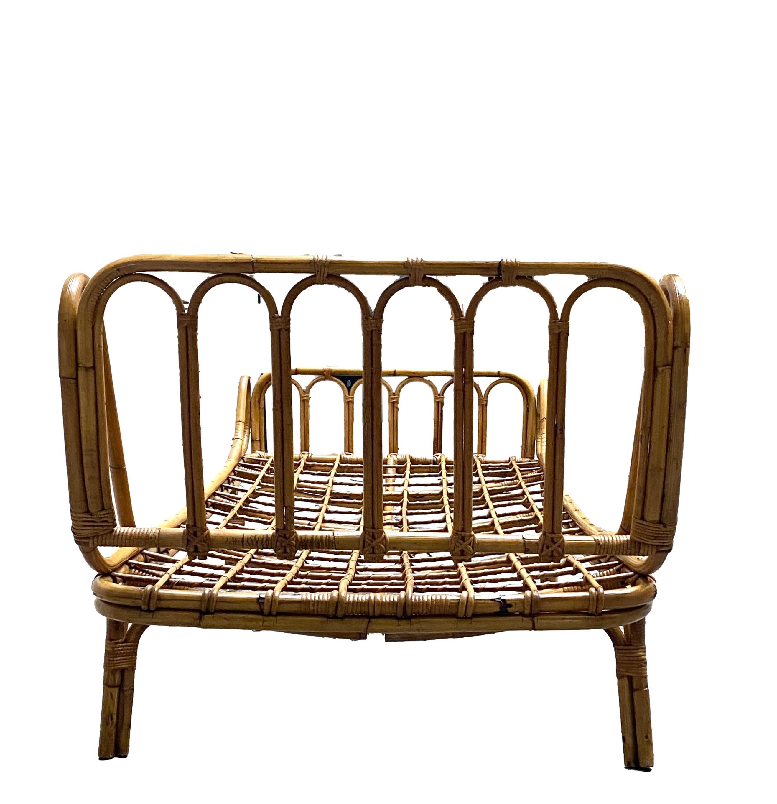 Italian rattan daybed in the style of Franco Albini and Franca Helg, circa 1960's. Long rattan bed with slatted sides and wrapped rattan detailing. Rattan is in good original vintage condition.