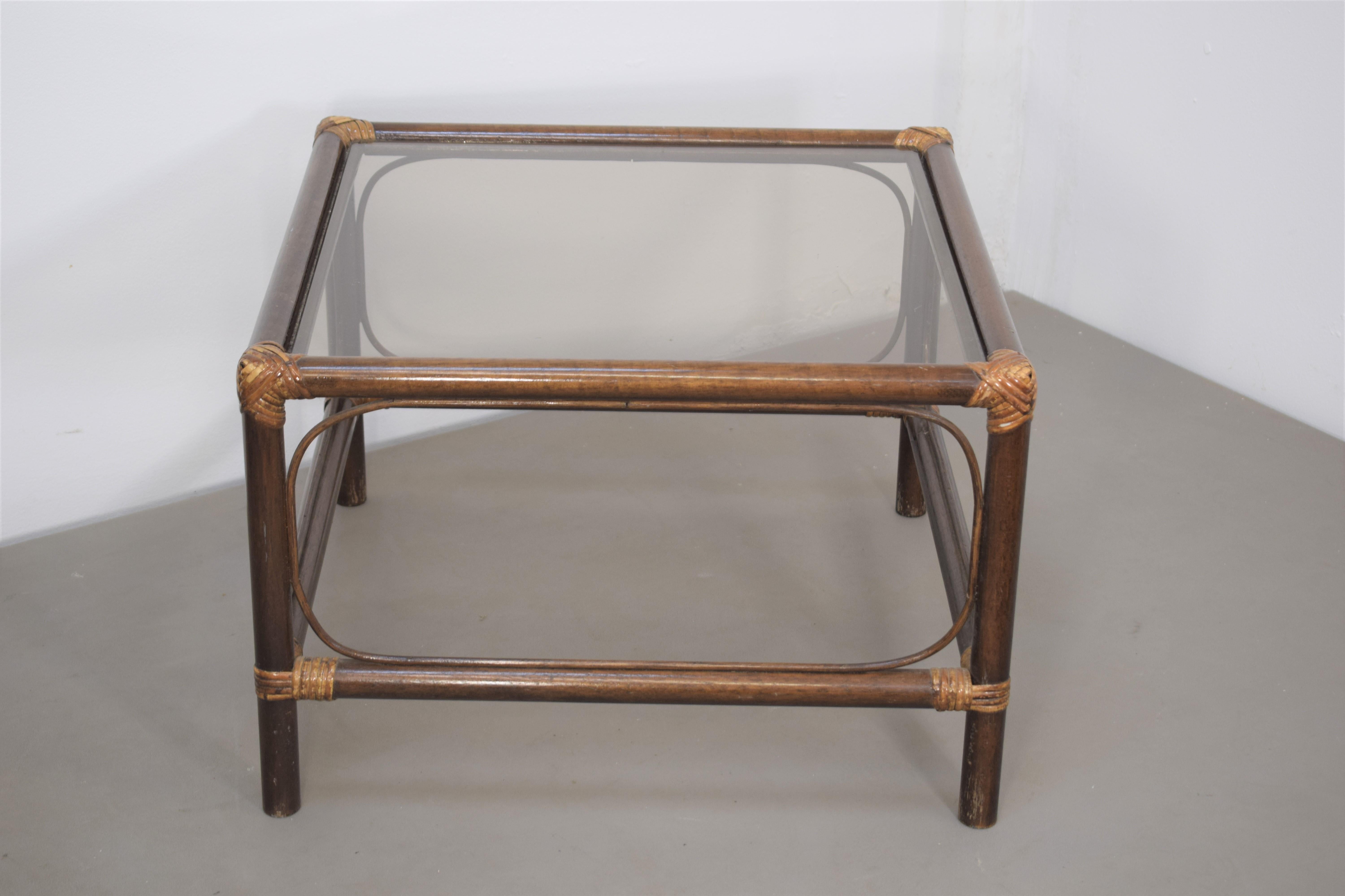 Italian bamboo and smoked glass coffee table, 1960s.

2 Pieces available. 

Dimensions: H= 40 cm; W= 60 cm; D= 60 cm.