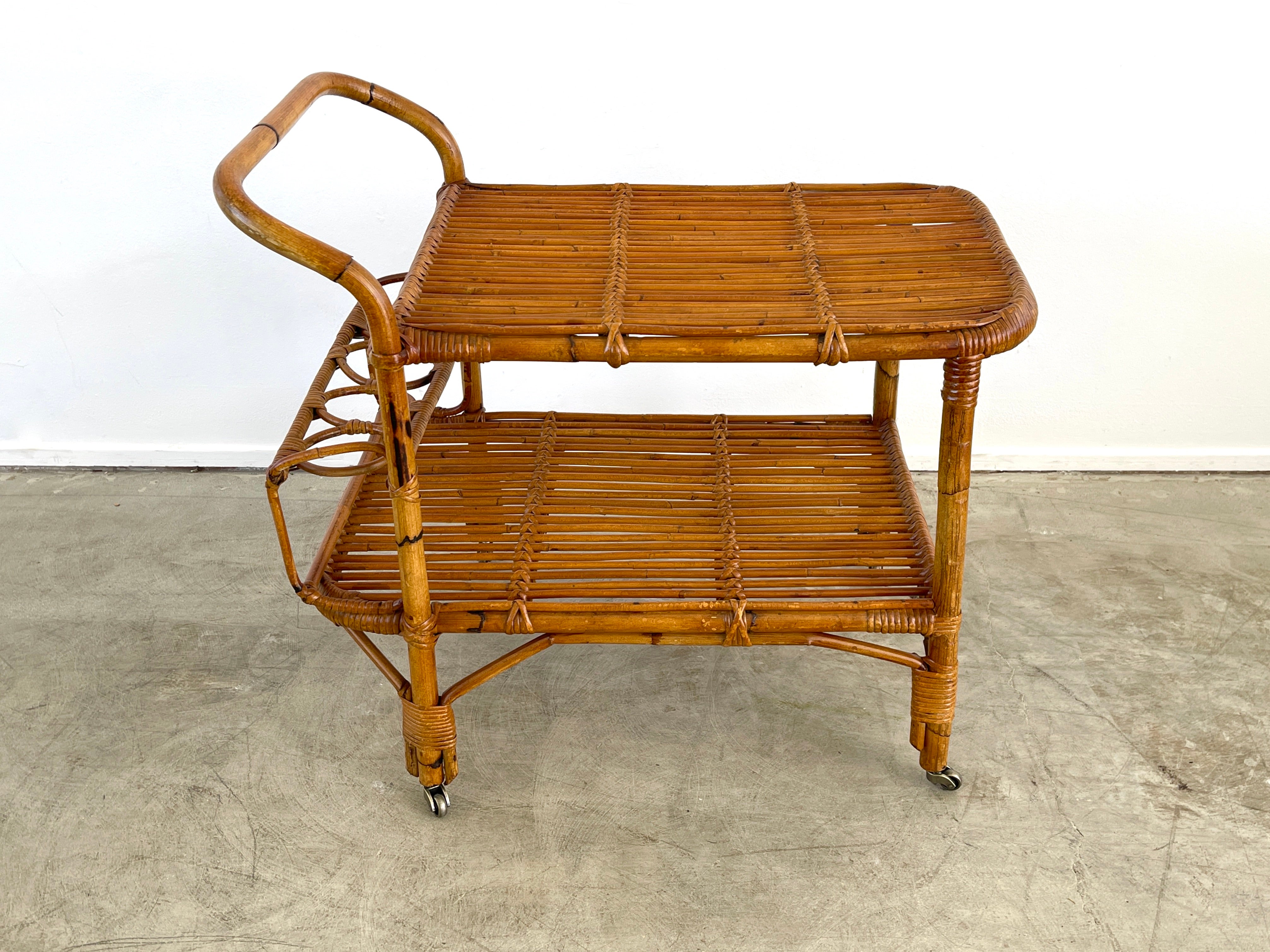 Italian bamboo bar cart with original casters and 2 tiers for storage. 
Circa 1960s.