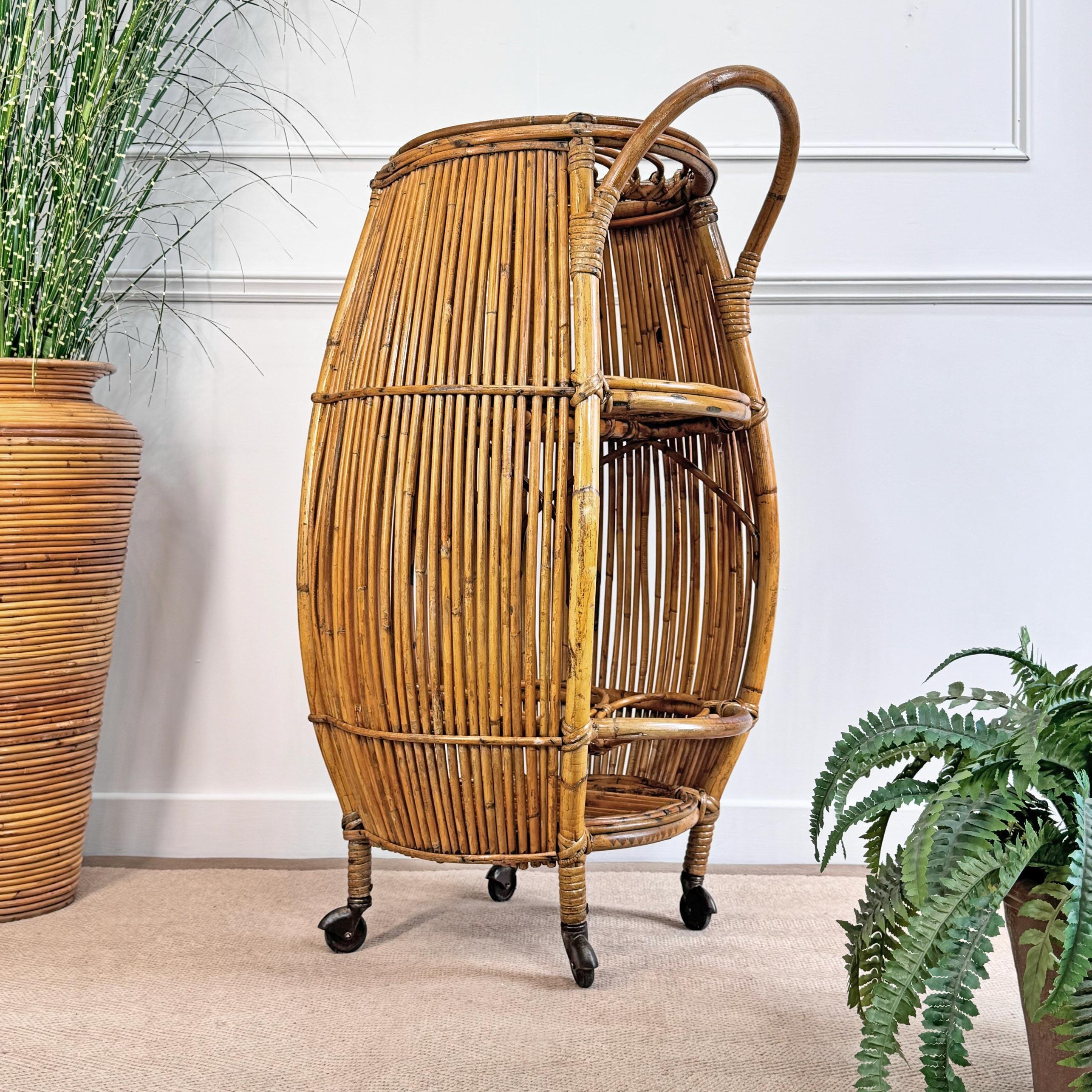 A fabulous 1960's Barrel Bar Cart by Italian designer Bonacina. Sitting on four brass wheels with an internal shelf and 7 bottle holders, the bambbo with rattan wrap. 



Height to top of Handle 96 cm x Width 49 cm x Depth 46 cm

92 cm Height to top
