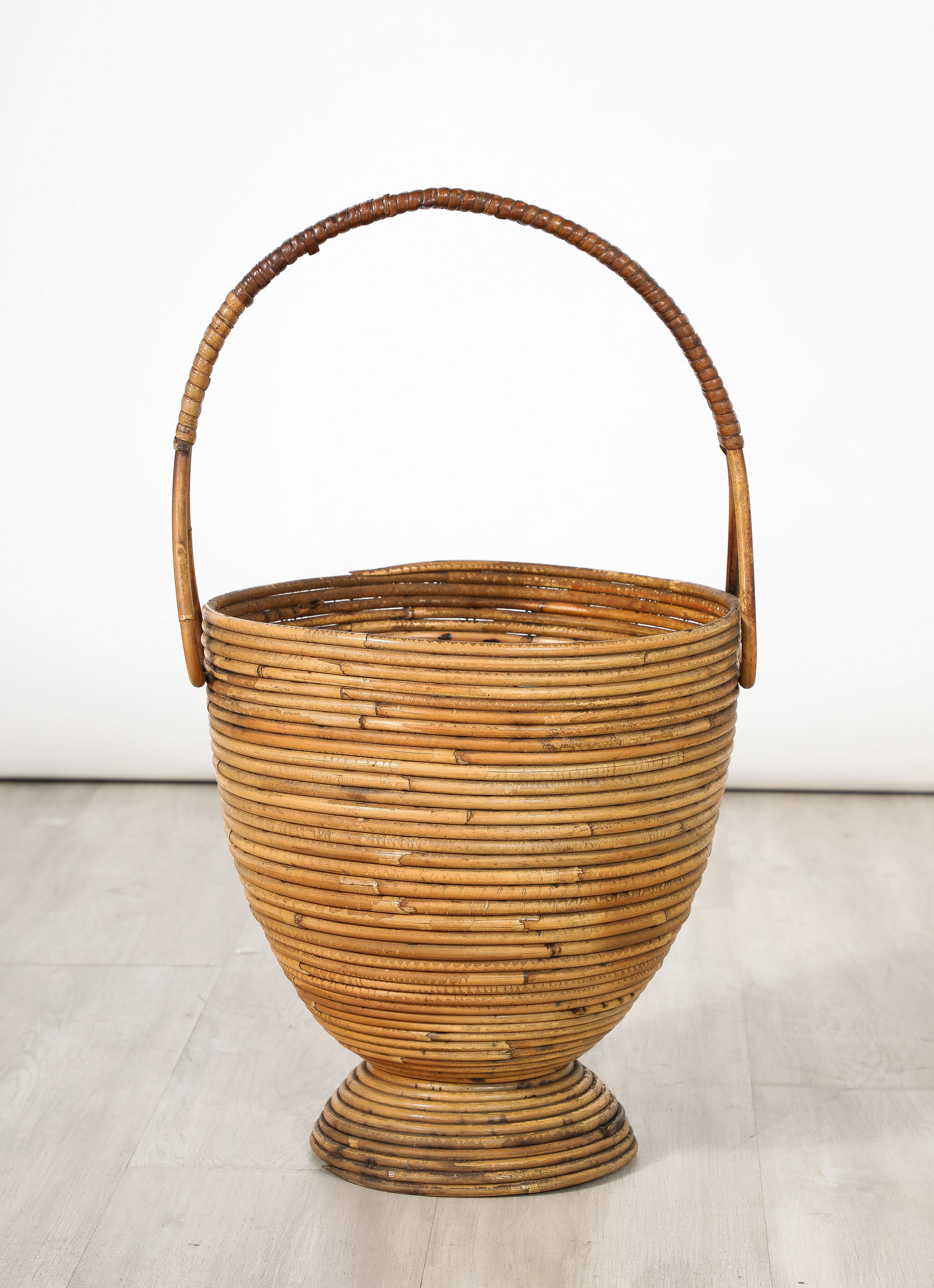 A charming Italian 1950's bamboo and wood hand-crafted basket with handle. 
Italy, circa 1950
Size: 23