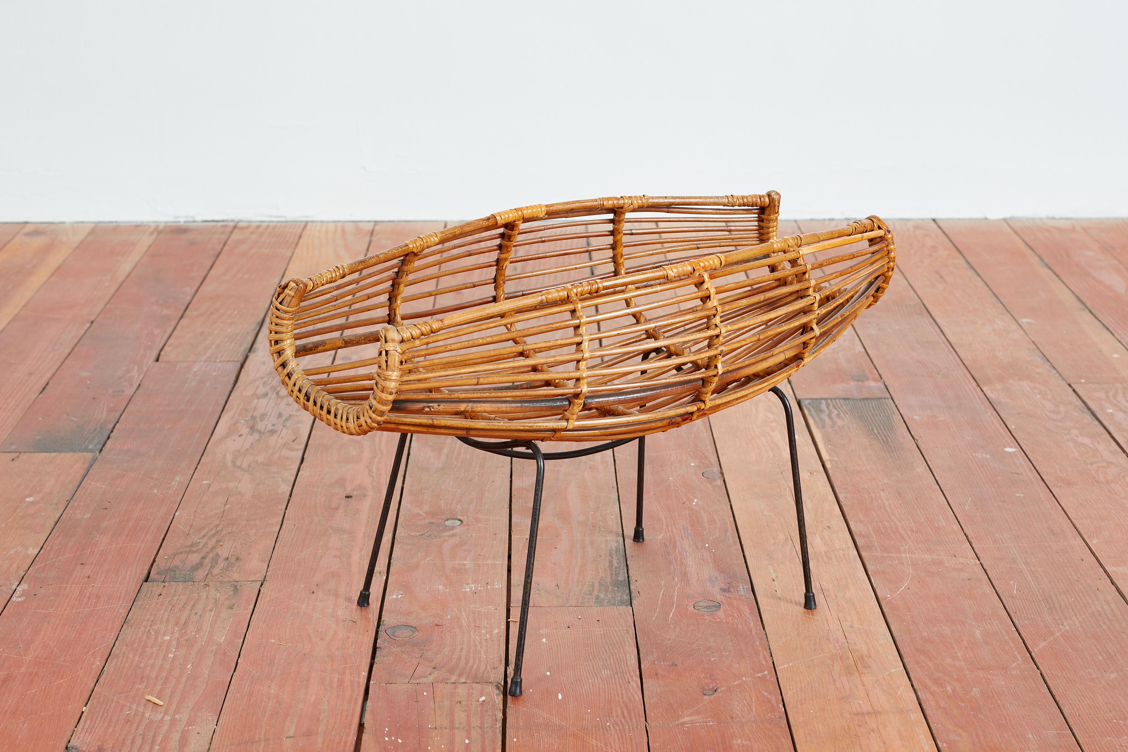Italian bamboo catchall basket with black iron base 
Sculptural in shape and great for fruit or magazines or just about anything you can think of!
Italy, 1950s