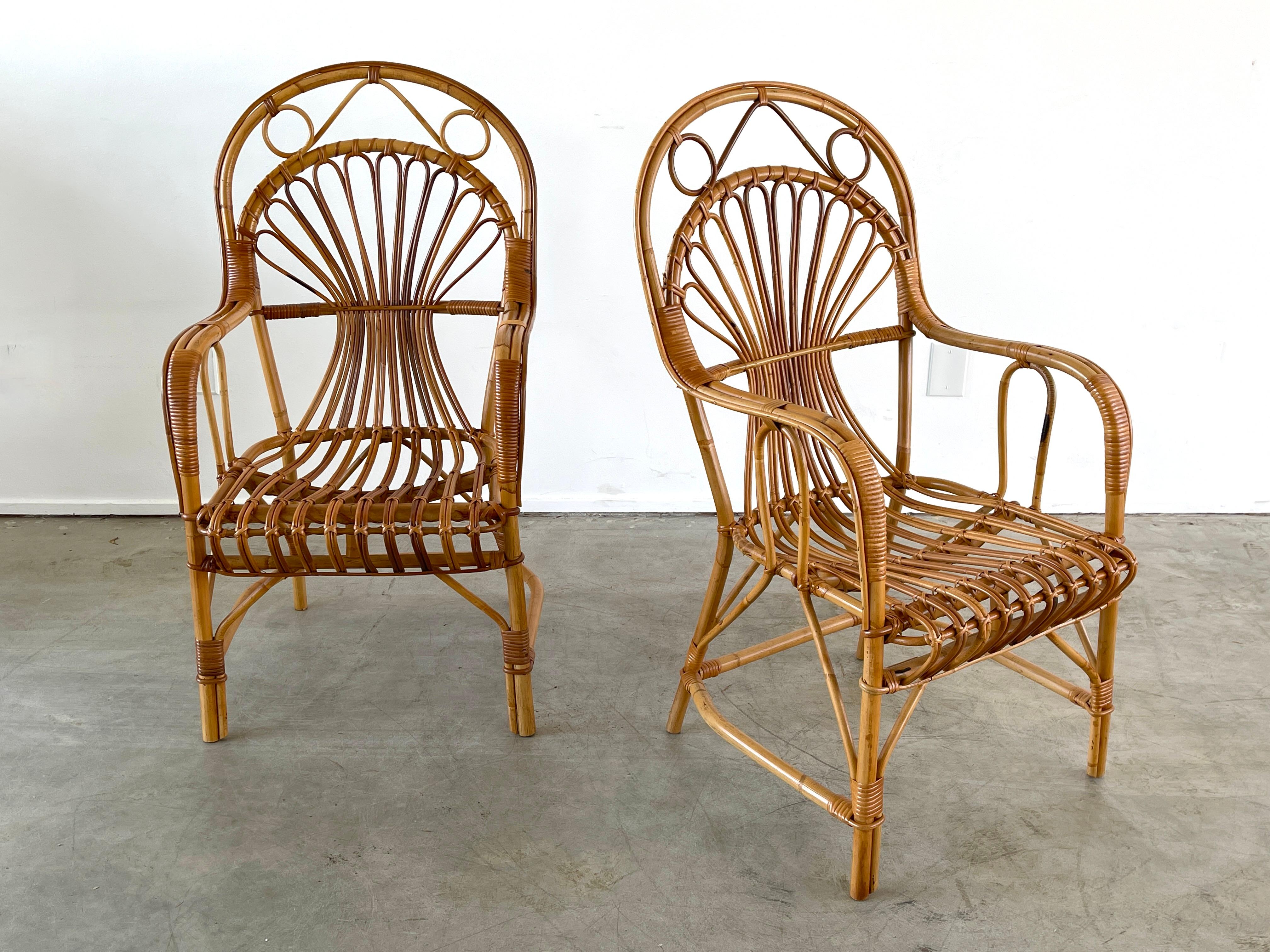 Whimsical pair of Italian bamboo chairs with curved backs and incredible detailing.
      